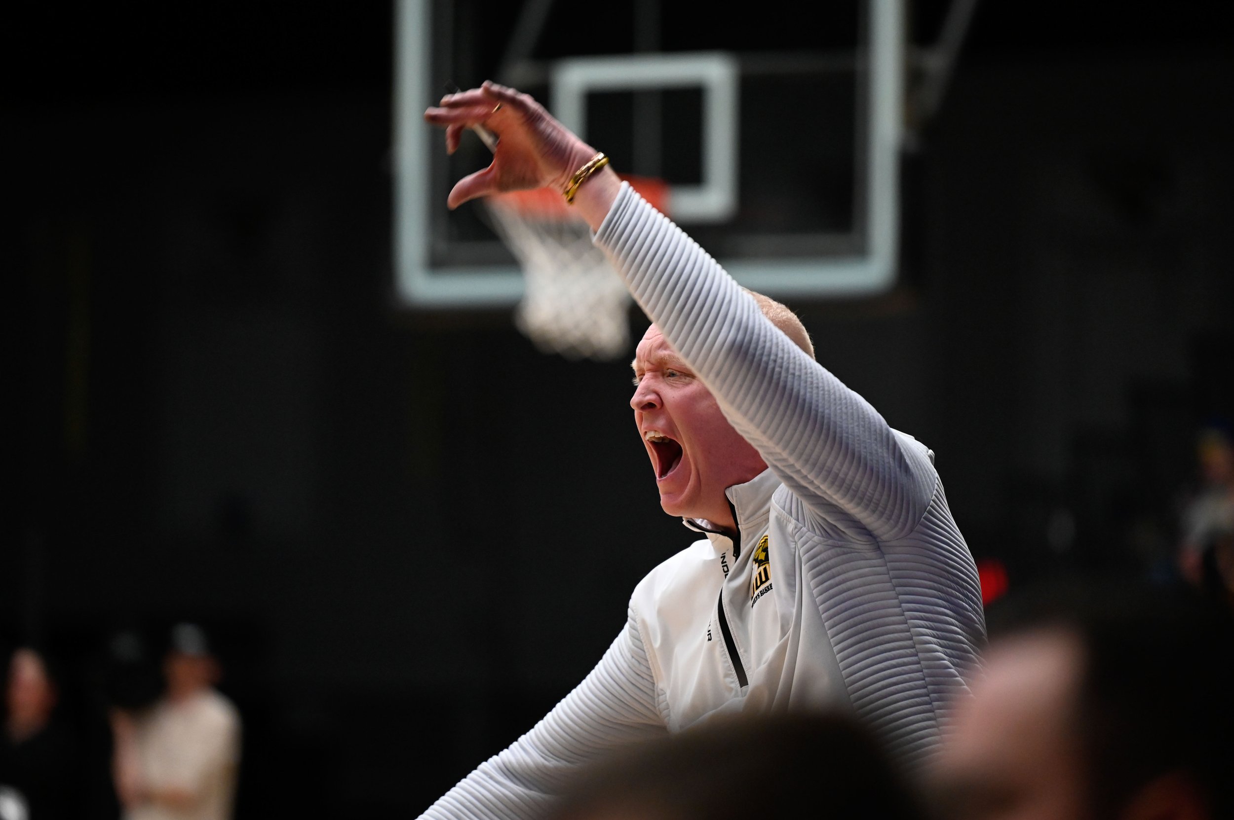 Brad Fischer, the head coach for the UW-Oshkosh women's basketball team, shouts during a tense game between Bethel University and UWO at Kolf Sports Center in Oshkosh, Wisconsin on March 8, 2025. The game determined who would move forward to the Swee