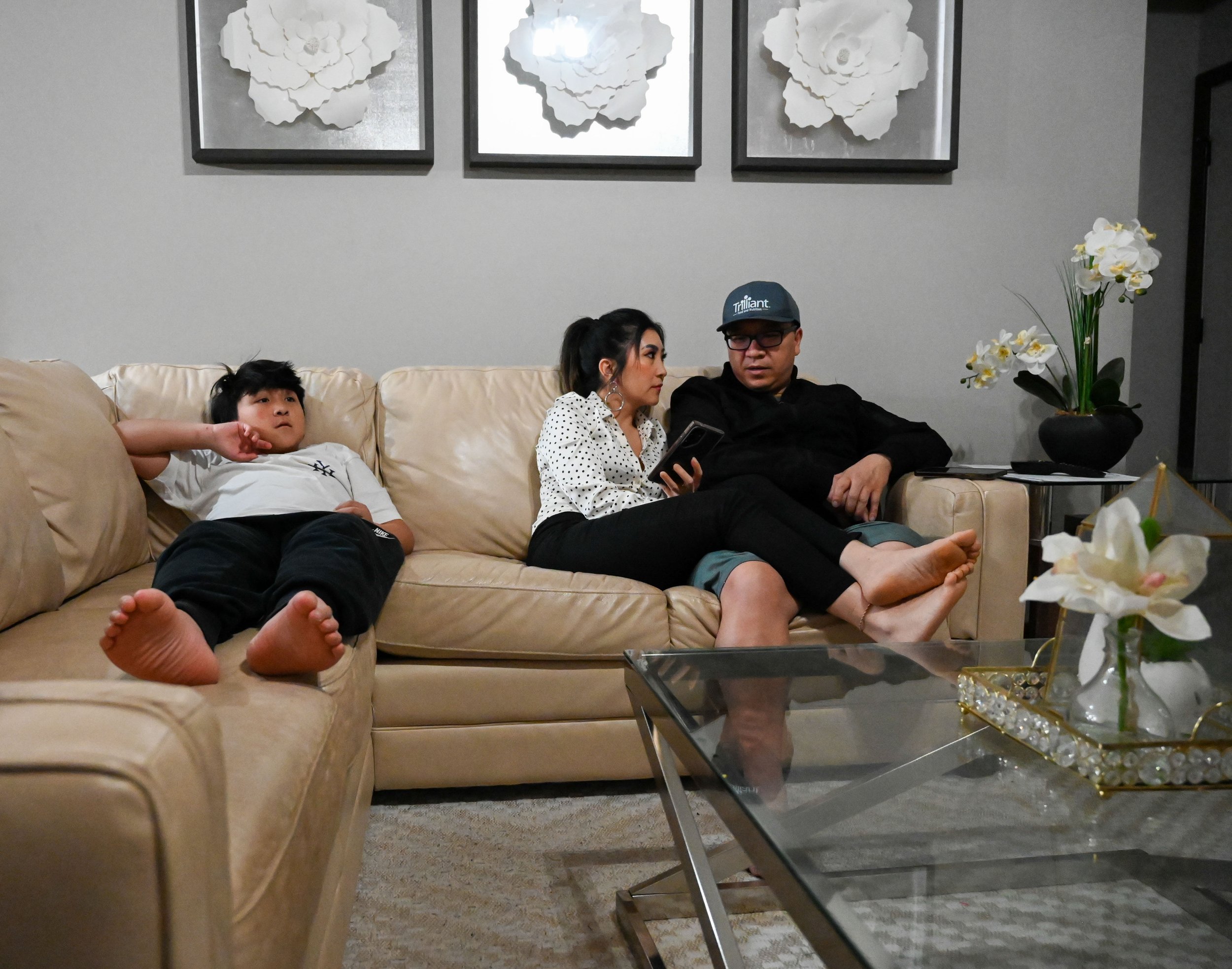 Mai Lee Vang and Sher Xiong speak in Hmong as their son watches a horror movie with them in Appleton, Wis., Tuesday, April 7, 2026. Xiong said his kids often spend their time in their rooms while they watch television in the evenings.
