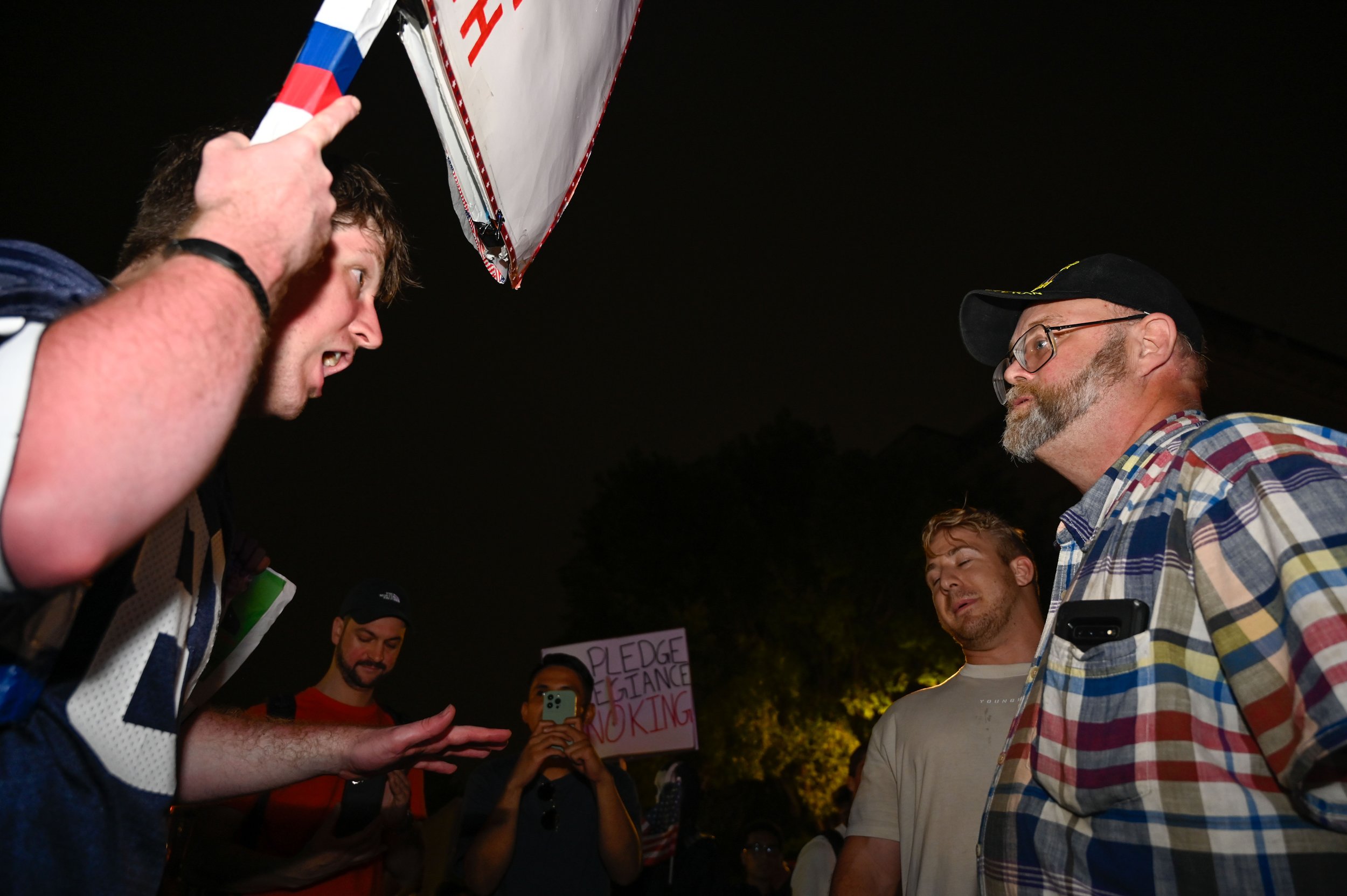 A protester argues with attendees of the Army's 250th birthday celebration outside the venue's exit in Washington, D.C., on June 14, 2025.