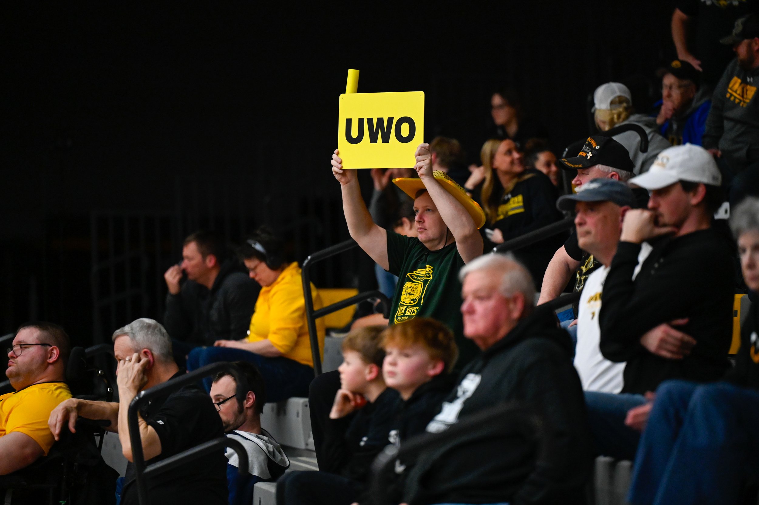 A man holds up a "UWO" sign at a women's basketball game between UW-Oshkosh and Calvin University at Kolf Sports Center on March 7, 2025. UWO beat Calvin University 61-52 that Friday. (Photo by Advance-Titan Photo Editor Jessica Duch)
