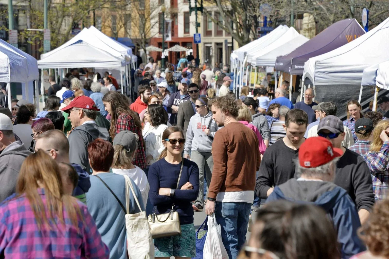 Color photo as published on timesunion.com: a crowd of shoppers fills River Street between the vendor tents at the market’s outdoor opening, May 5, 2018. Photo by John Carl D’Annibale, Times Union.