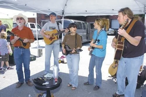 Color photo as published on troyrecord.com: musicians performing at the Troy Waterfront Farmers Market’s outdoor opening, May 1, 2010. Photo by J.S. Carras, The Record.