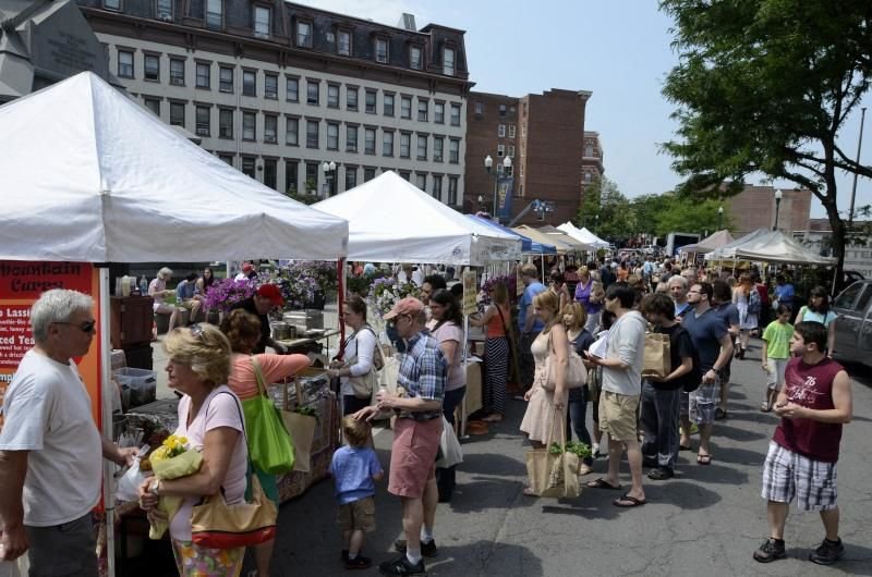 Color photo as published on troyrecord.com: crowds among the vendor tents of the Troy Waterfront Farmers’ Market on River Street in downtown Troy, June 22, 2013. Photo by Mike McMahon, The Record.