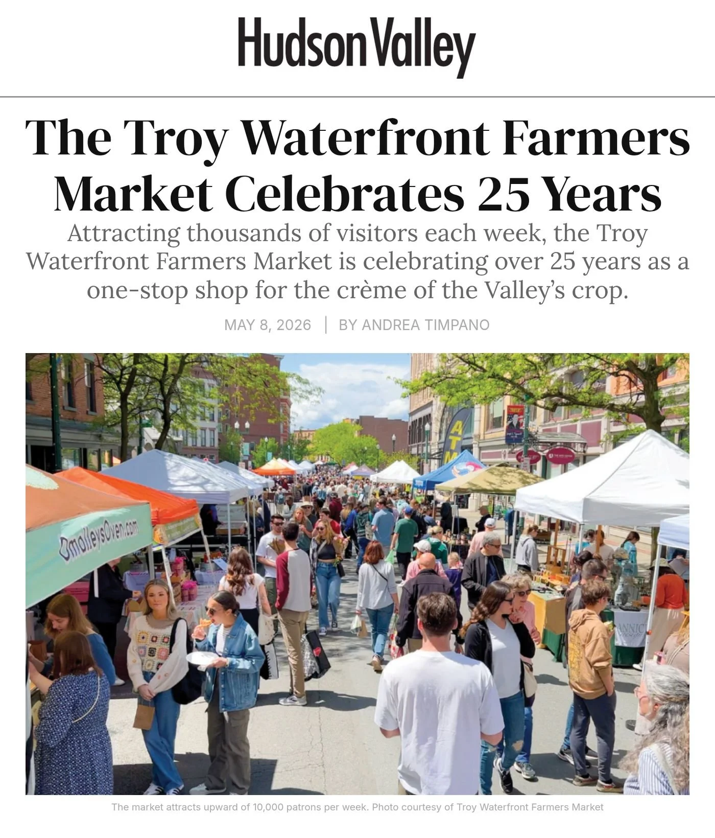 Hudson Valley Magazine website, May 8, 2026: ‘The Troy Waterfront Farmers Market Celebrates 25 Years’ by Andrea Timpano, with a photo of crowds filling a downtown street lined with vendor tents.