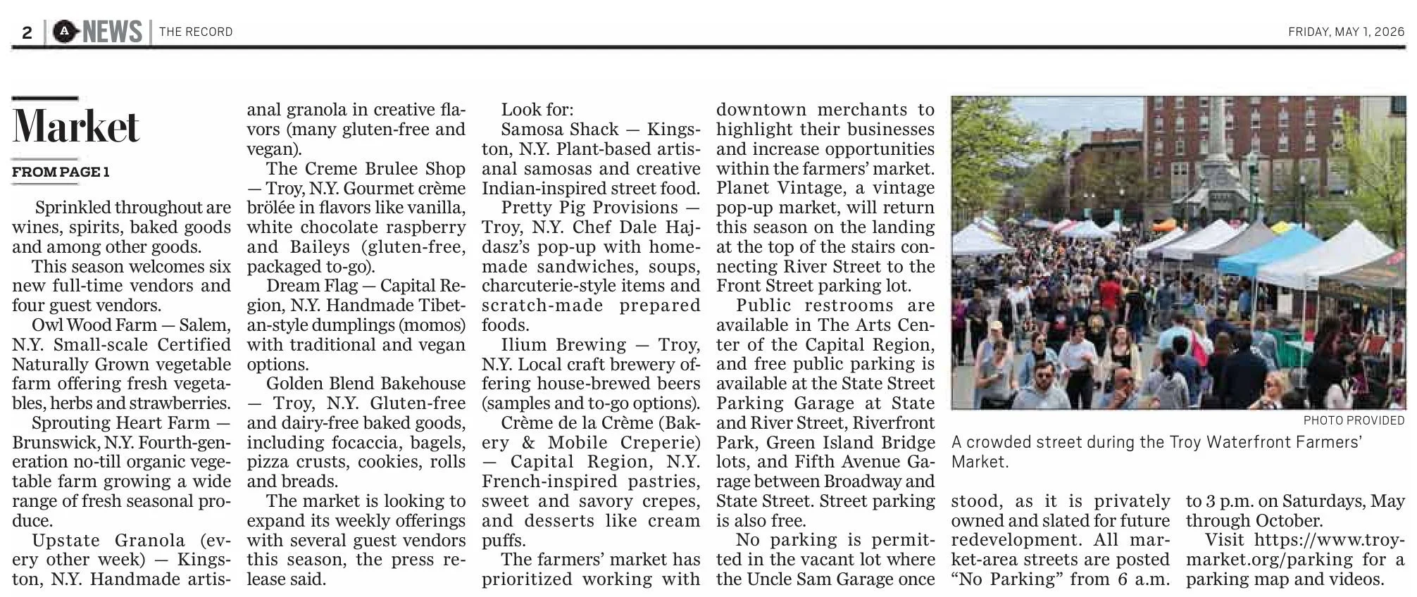 The Record page A2, Friday, May 1, 2026: continuation of “Moving Outside” from the front page, with the list of new and guest vendors, parking information, and a photo of a crowded market street.
