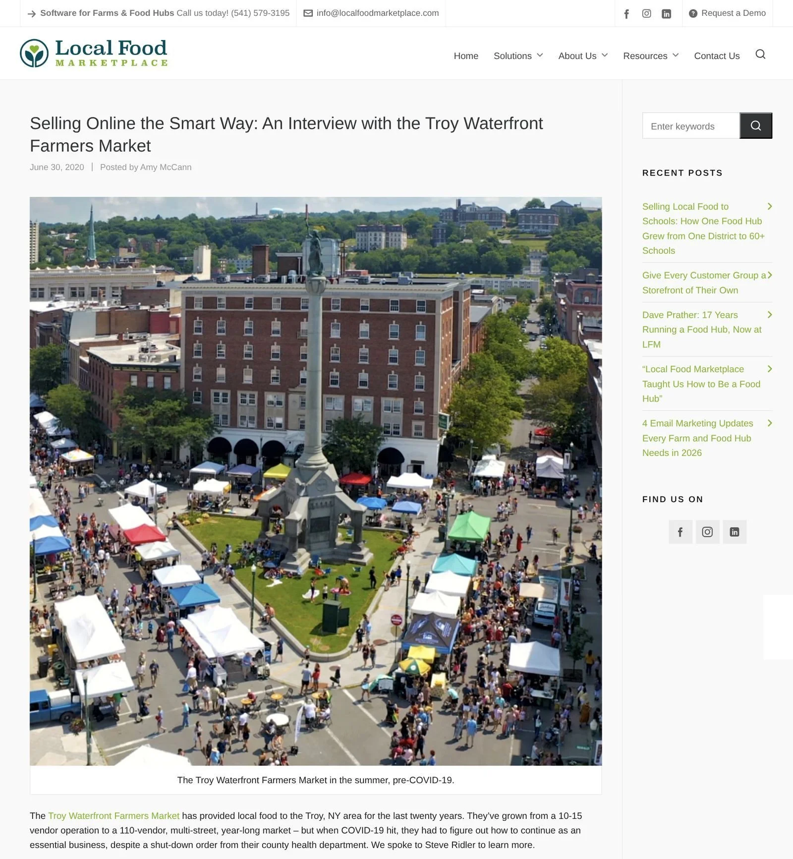 Local Food Marketplace website, June 30, 2020: 'Selling Online the Smart Way: An Interview with the Troy Waterfront Farmers Market' by Amy McCann, with an aerial photo of the market's tents and crowds around the Monument Square column in Troy.
