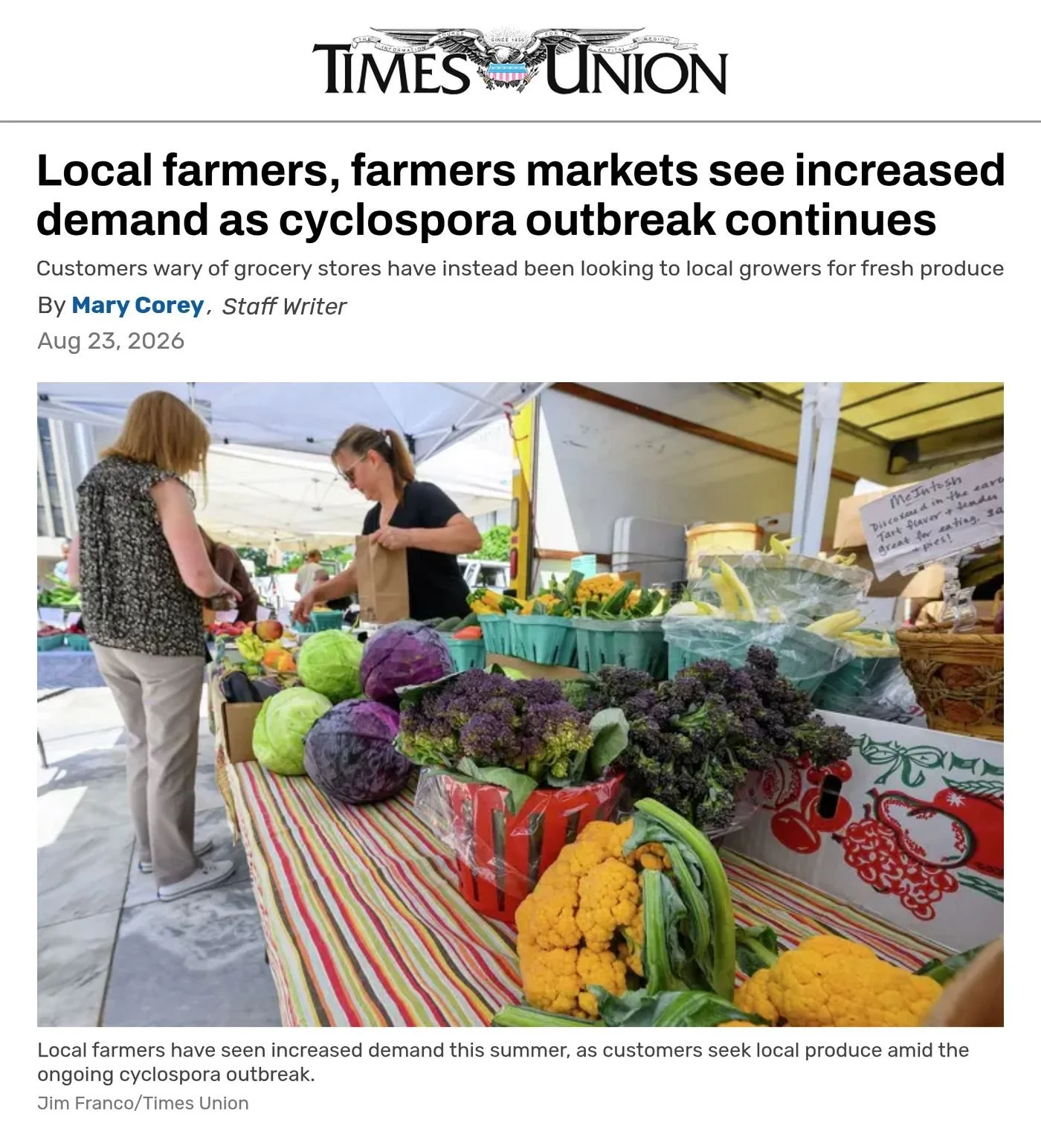 Times Union website, Aug. 23, 2026: ‘Local farmers, farmers markets see increased demand as cyclospora outbreak continues’ by Mary Corey, with a photo of a farm stand table piled with cauliflower, cabbage and other fresh vegetables.