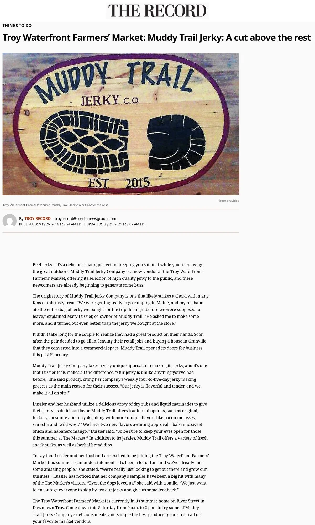 The Record website, May 26, 2016: 'Troy Waterfront Farmers' Market: Muddy Trail Jerky: A cut above the rest,' with a photo of the Muddy Trail Jerky Co. wooden sign with two boot prints, profiling the new market vendor.