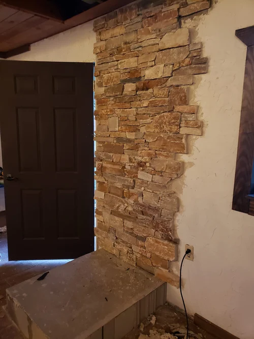 Stone wall going up for the wood-burning stove.