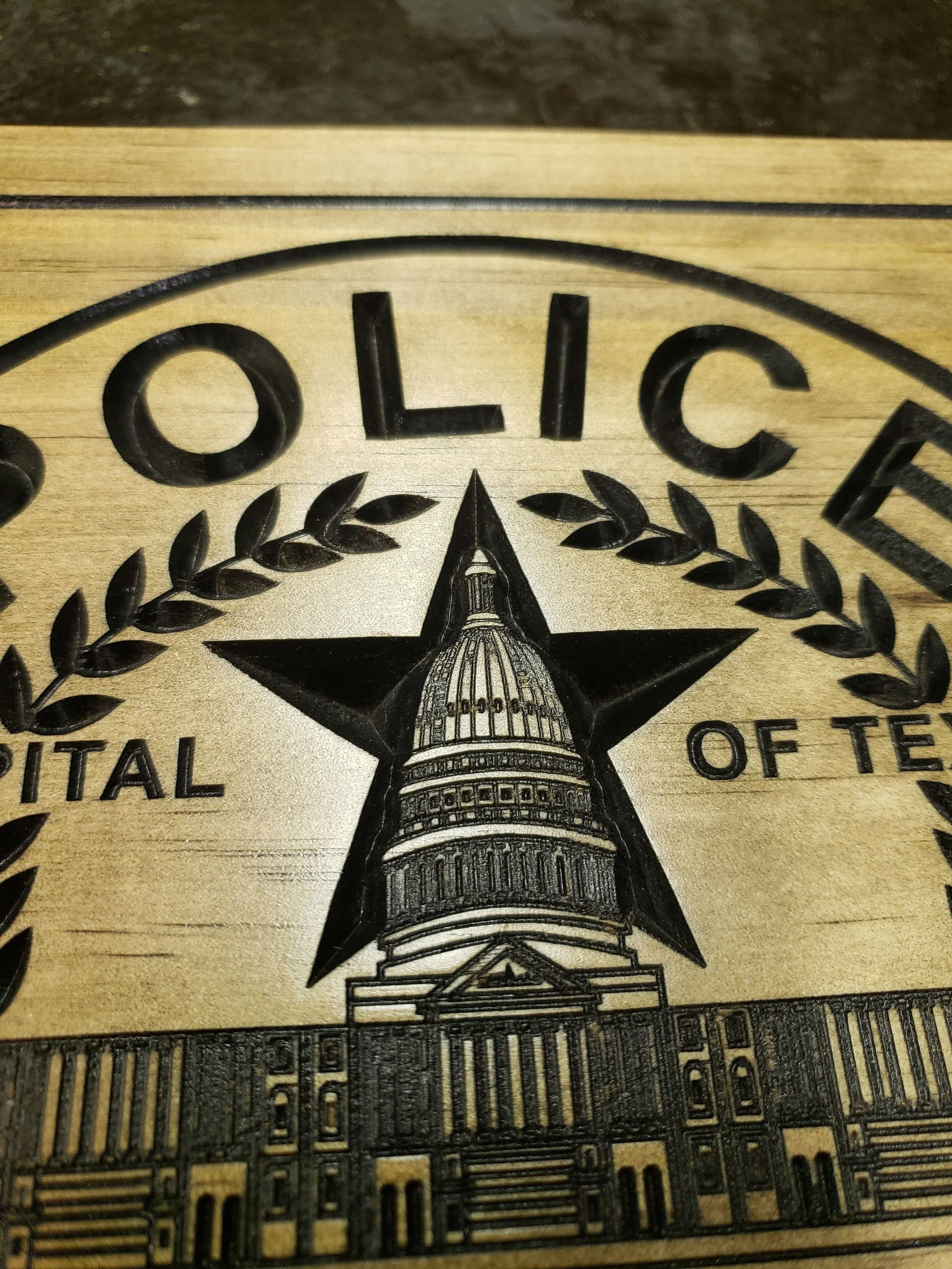 wooden police emblem carved