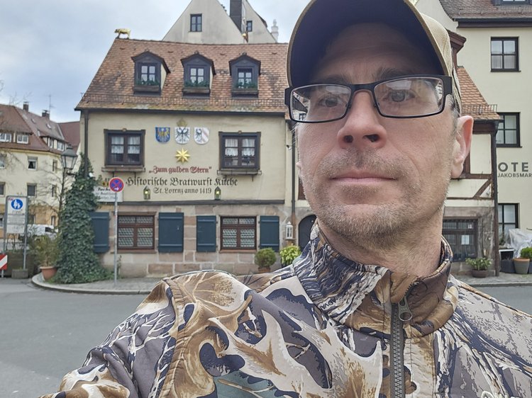 Stefan taking a selfie in front of the historic Zum goldenen Engel bratwurst kitchen in Germany.