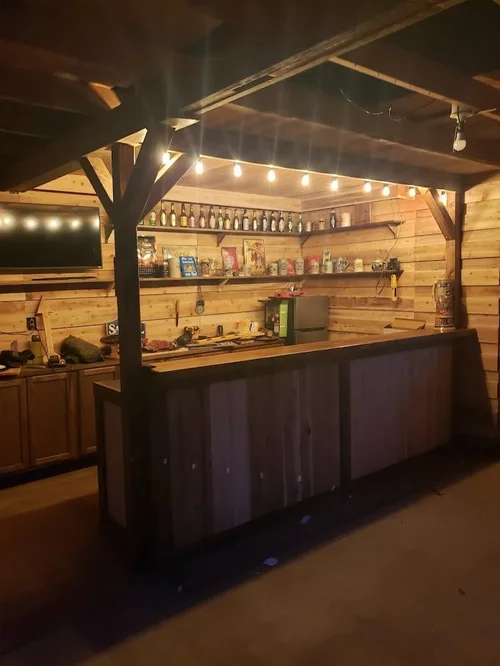 Finished rustic bar lit by string lights.