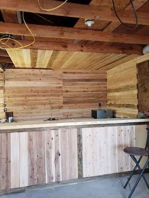 Wood-paneled bar area under construction.