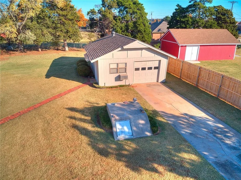 Aerial view of the backyard with the original white garage before the conversion.