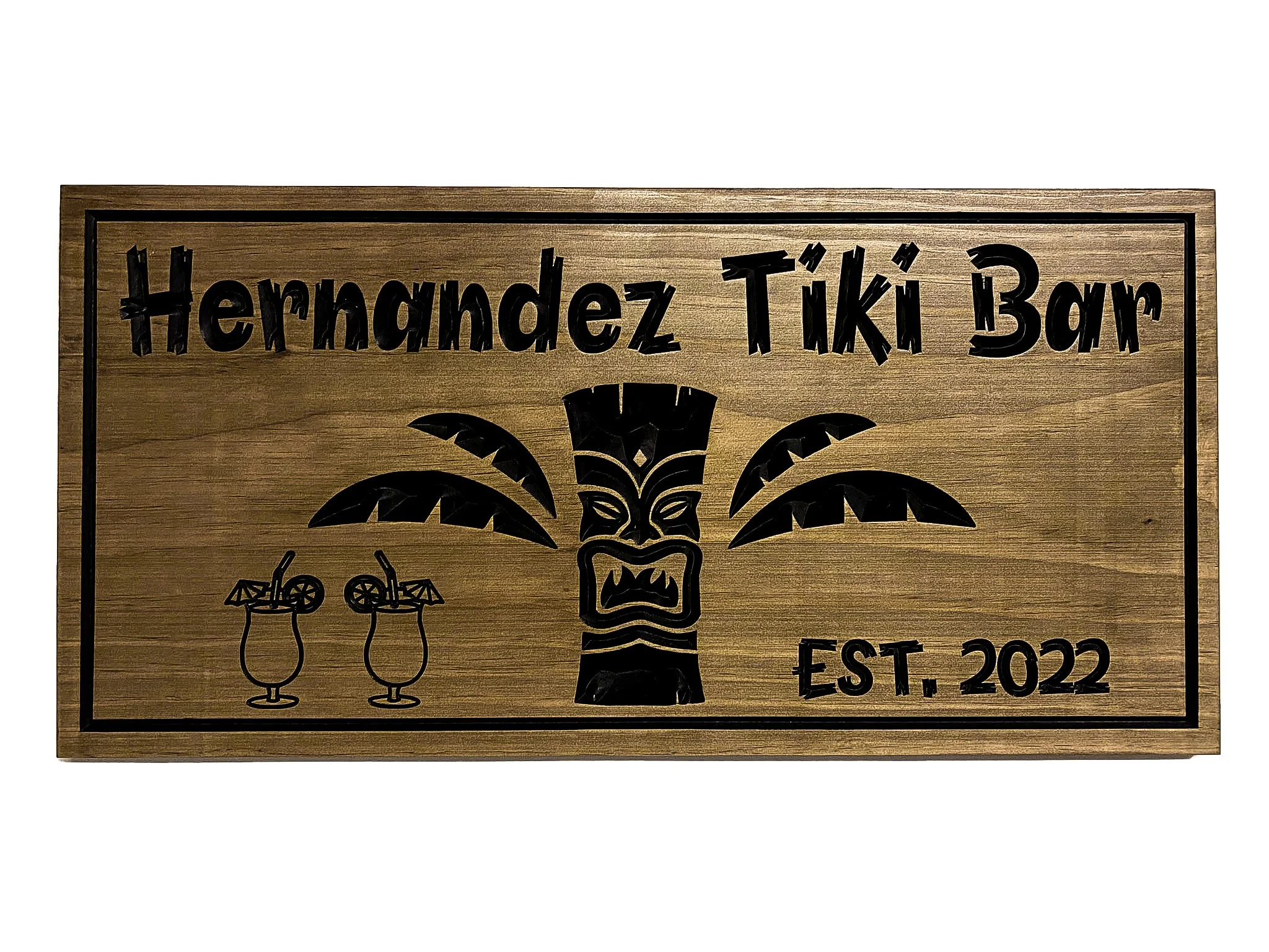 Close-up detail of hand carved wooden Tiki mask with intricate headdress and facial features on custom Tiki Bar sign