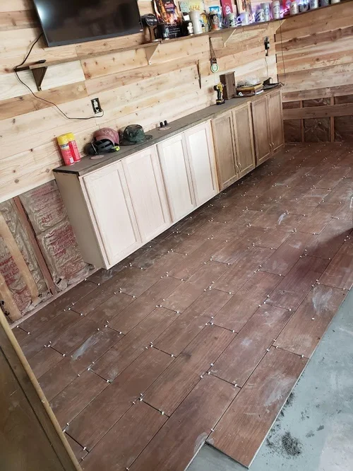 New flooring being installed beside the bar.