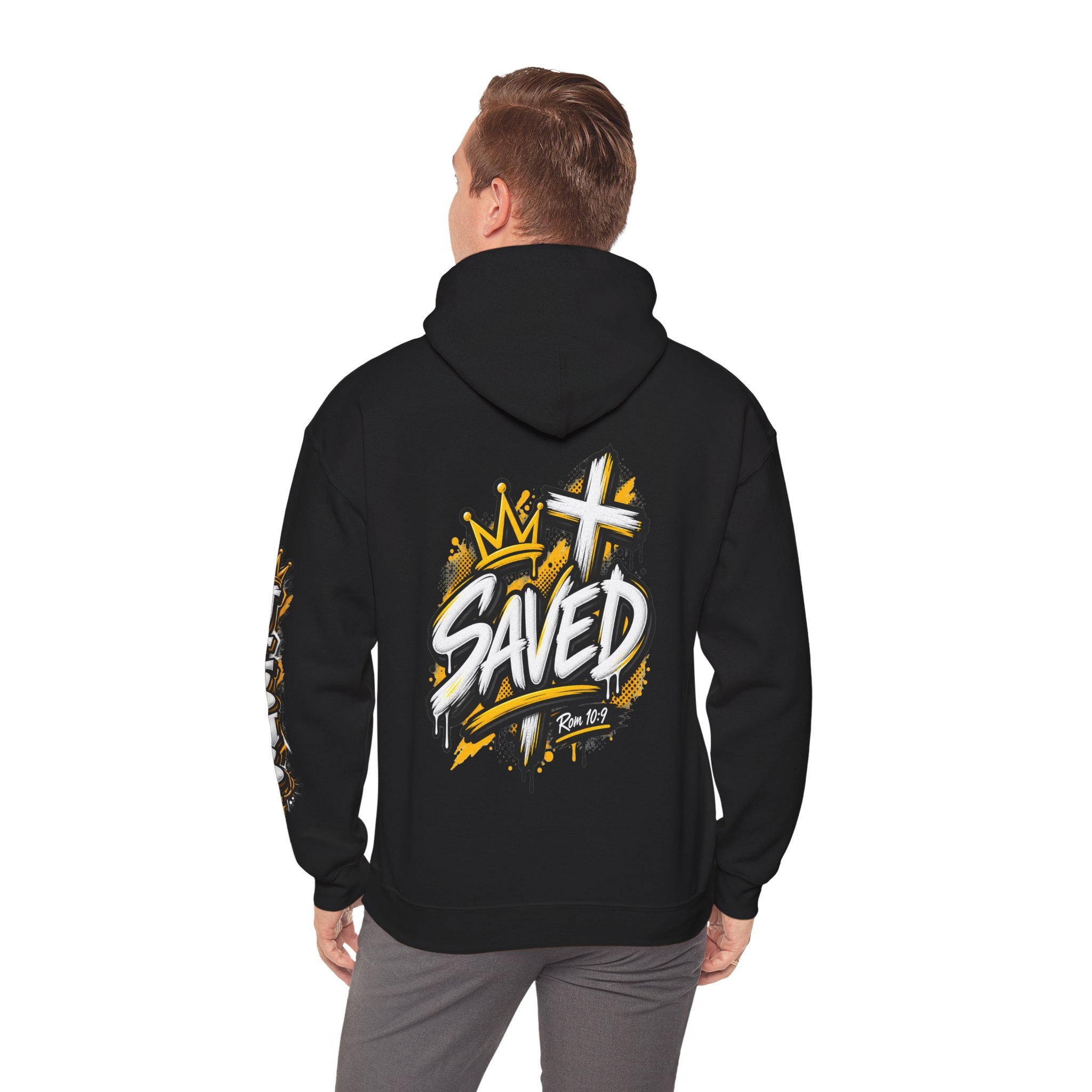Black Unisex streetwear hoodie featuring bold graffiti-style 'SAVED' lettering, a crown, a cross, halftone patterns, and 'Rom 10:9'.