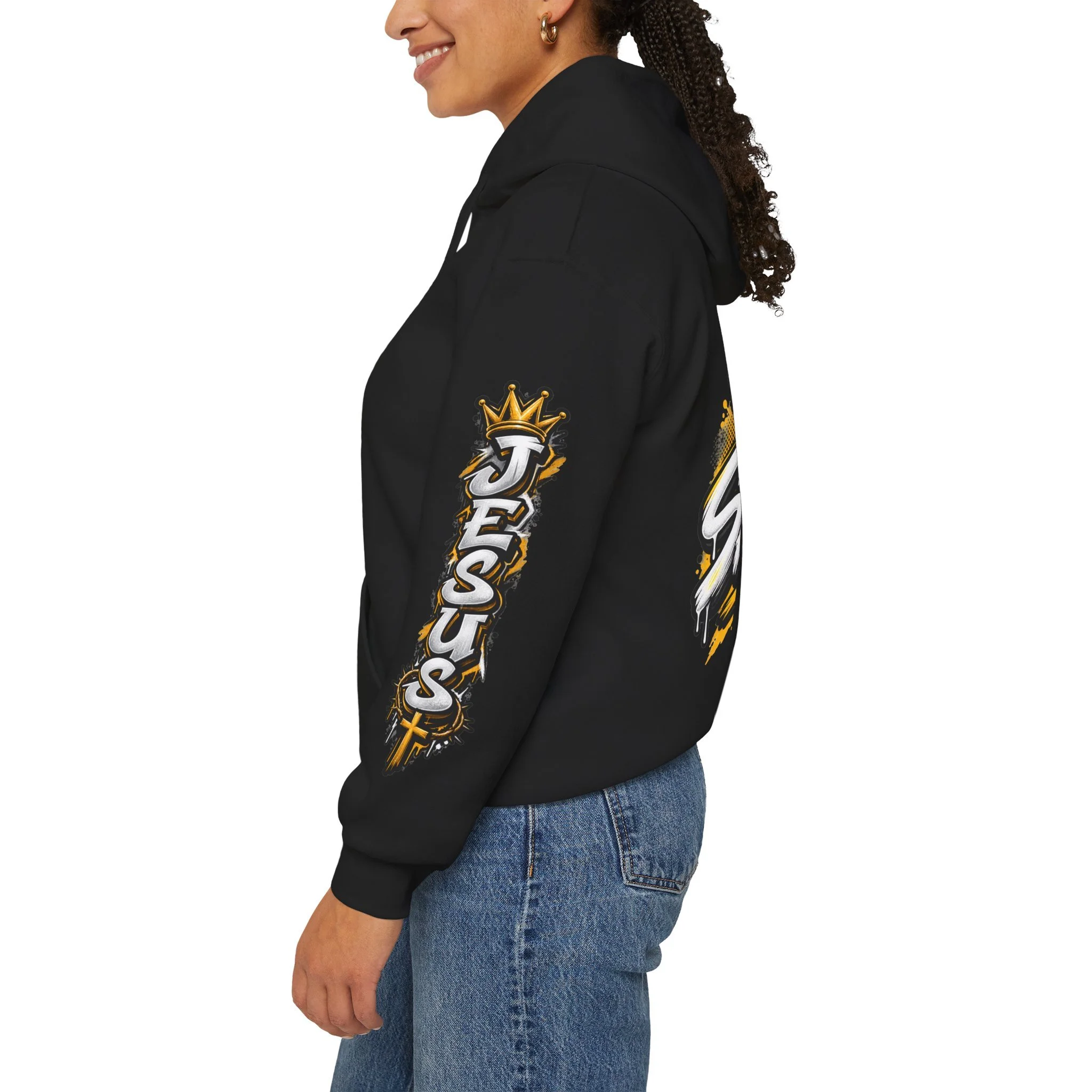 Black Unisex streetwear hoodie featuring bold graffiti-style 'SAVED' lettering, a crown, a cross, halftone patterns, and 'Rom 10:9'.