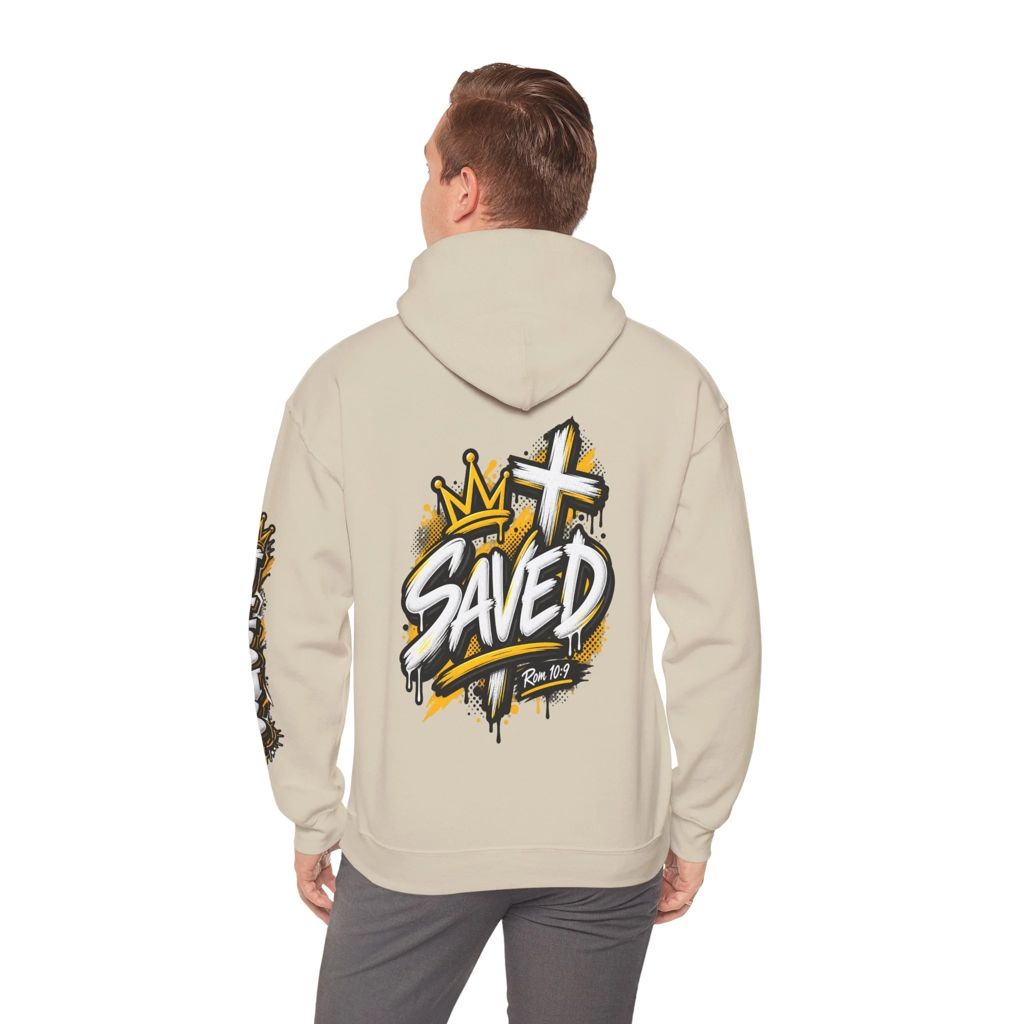 Sand Unisex streetwear hoodie featuring bold graffiti-style 'SAVED' lettering, a crown, a cross, halftone patterns, and 'Rom 10:9'.