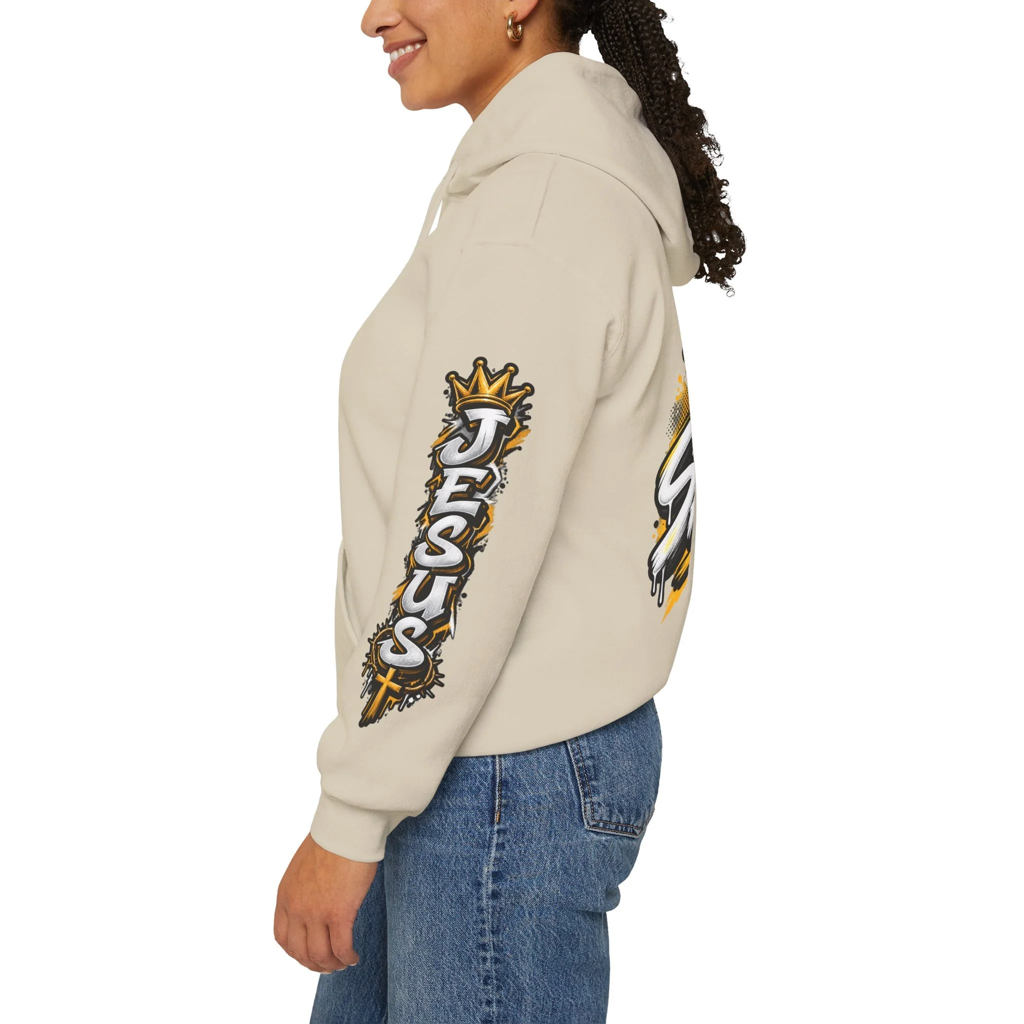 Sand Unisex streetwear hoodie featuring bold graffiti-style 'SAVED' lettering, a crown, a cross, halftone patterns, and 'Rom 10:9'.