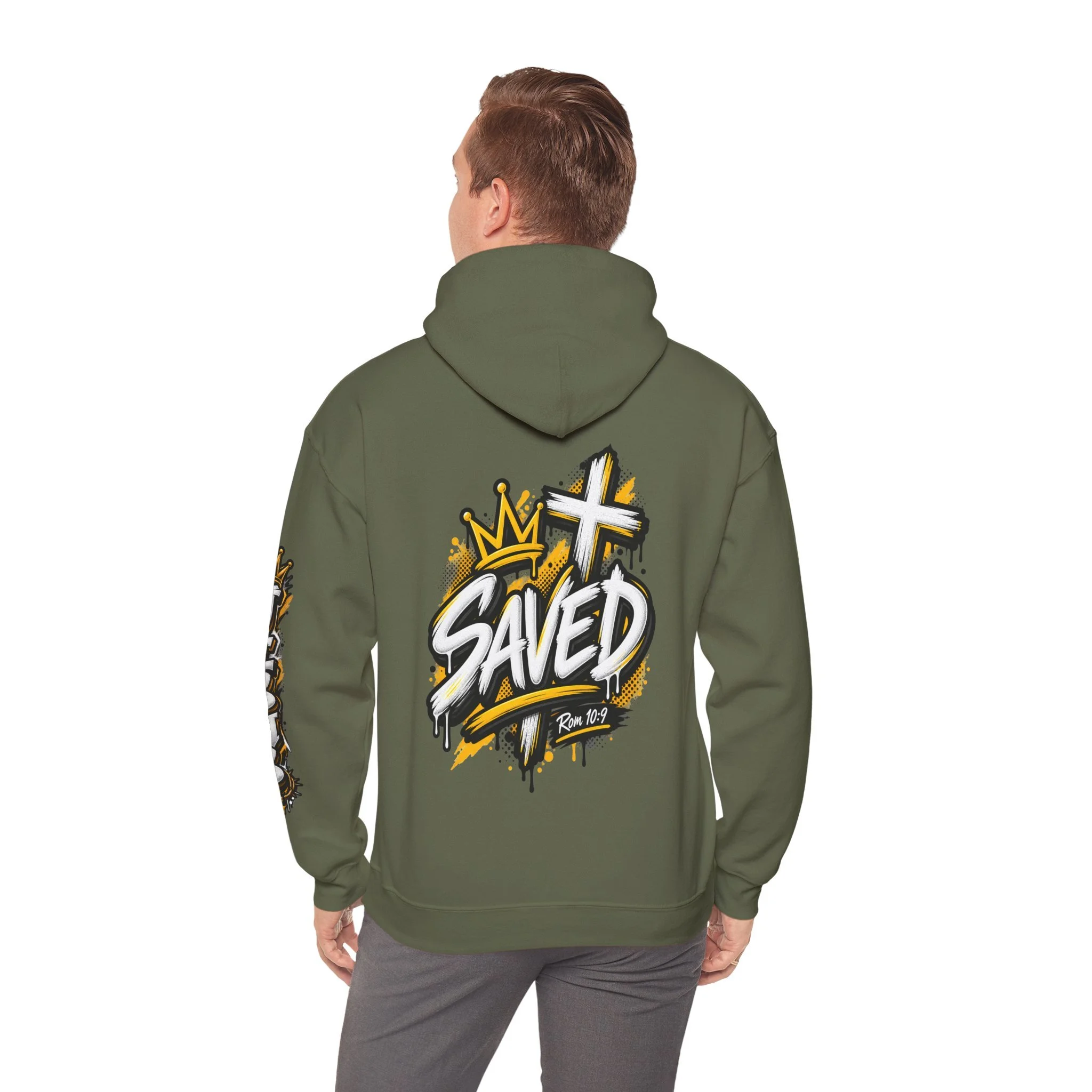 Military green Unisex streetwear hoodie featuring bold graffiti-style 'SAVED' lettering, a crown, a cross, halftone patterns, and 'Rom 10:9'.