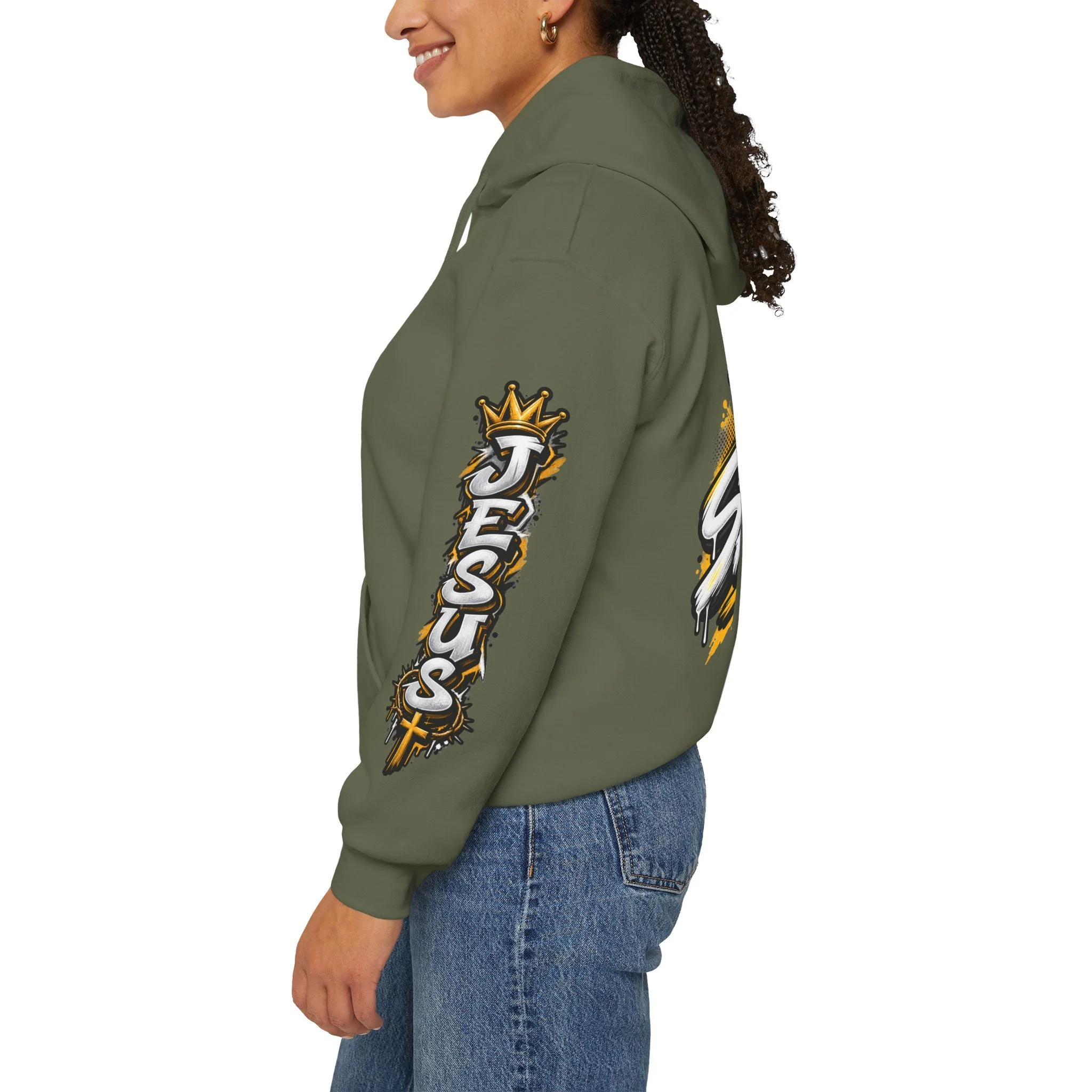 Military Green Unisex streetwear hoodie featuring bold graffiti-style 'SAVED' lettering, a crown, a cross, halftone patterns, and 'Rom 10:9'.