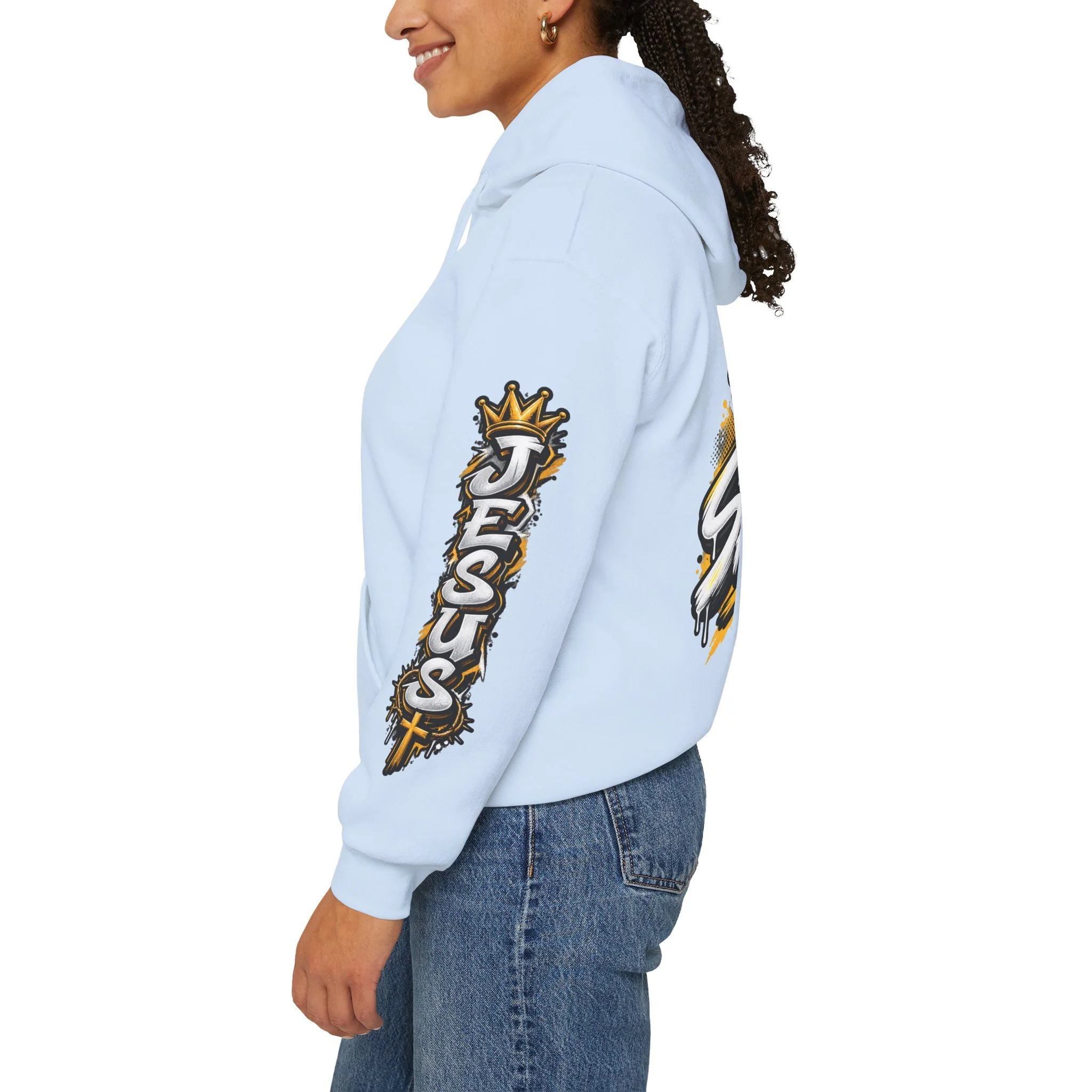 Light Blue Unisex streetwear hoodie featuring bold graffiti-style 'SAVED' lettering, a crown, a cross, halftone patterns, and 'Rom 10:9'.