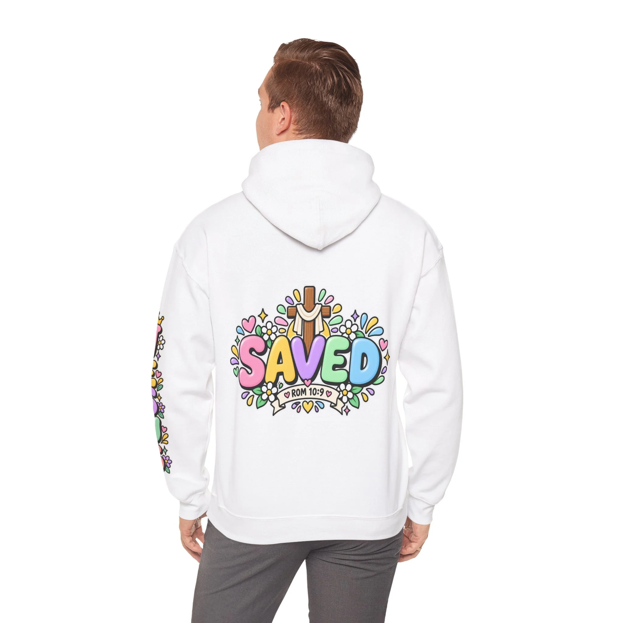 White Unisex pastel hoodie featuring cute 3D bubble letters spelling SAVED with flowers, hearts, a wooden cross, and a banner reading ROM 10:9.