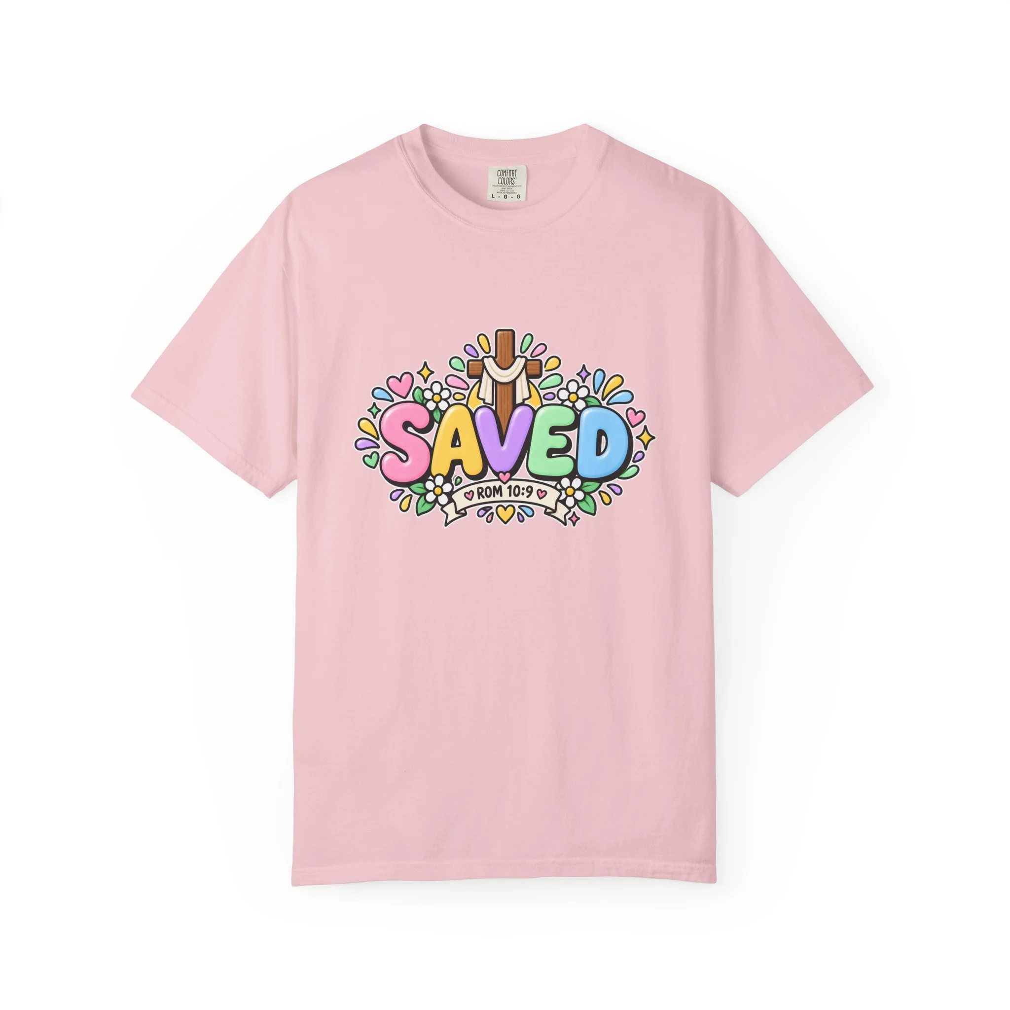 Light pink pastel hoodie featuring cute 3D bubble letters spelling SAVED with flowers, hearts, a wooden cross, and a banner reading ROM 10:9.