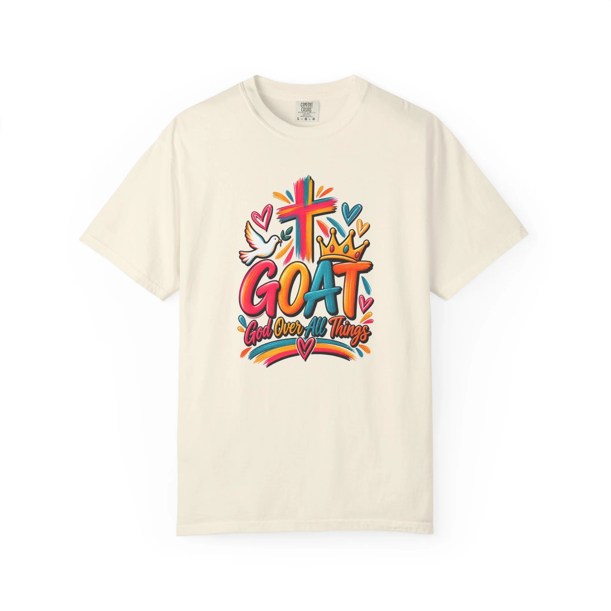 Sand unisex t-shirt graphic showing bright, colorful modern script that reads GOAT and "God Over All Things", accented with a painted cross, crown, hearts, and a dove.
