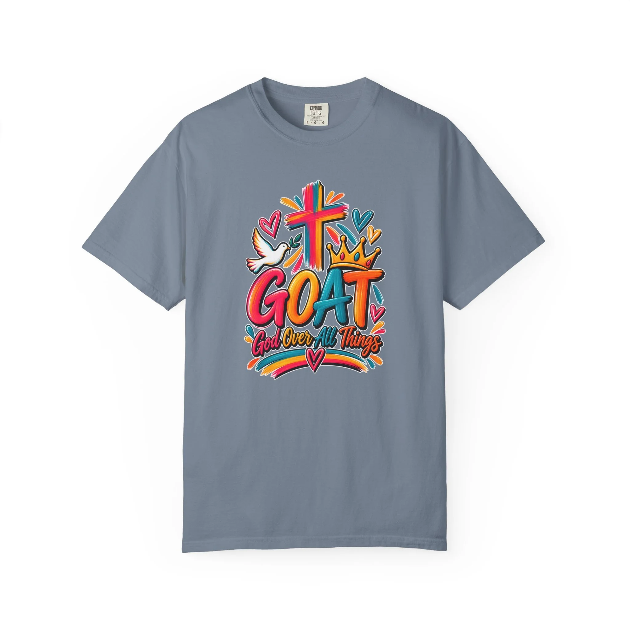 Denim blue unisex t-shirt graphic showing bright, colorful modern script that reads GOAT and "God Over All Things", accented with a painted cross, crown, hearts, and a dove.