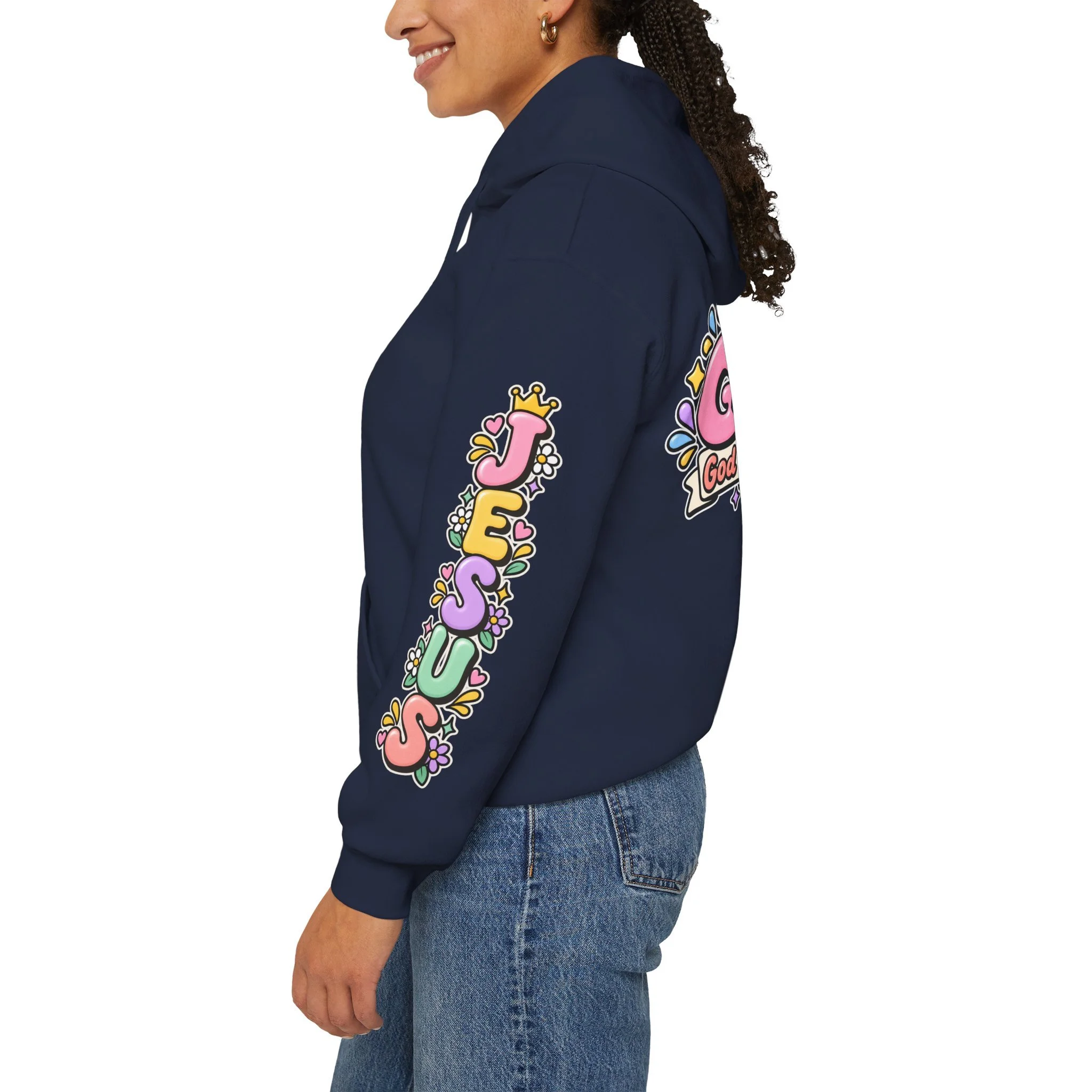 Navy blue unisex hoodie featuring cute 3D pastel bubble letters spelling GOAT with a crown, a cross integrated into the letter T, hearts, sparkles, and a banner reading "God Over All Things".