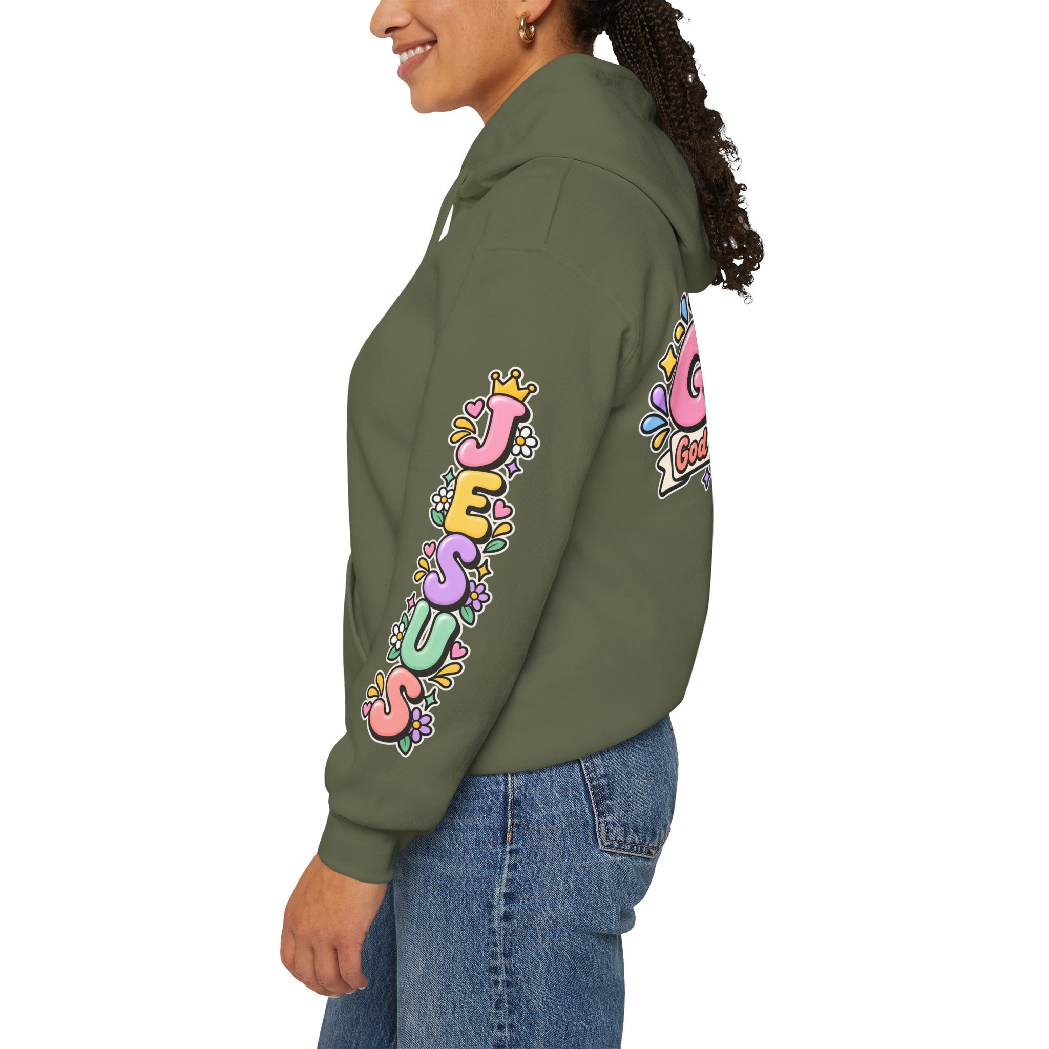 Military green unisex hoodie featuring cute 3D pastel bubble letters spelling GOAT with a crown, a cross integrated into the letter T, hearts, sparkles, and a banner reading "God Over All Things".
