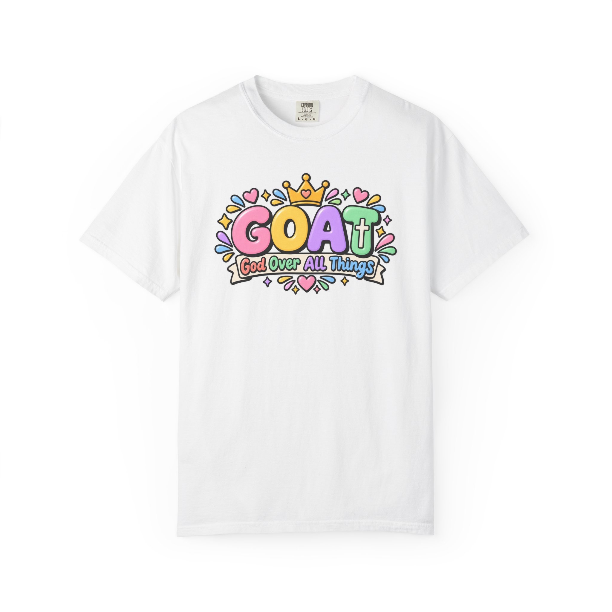 White unisex t-shirt graphic showing cute 3D pastel bubble letters spelling GOAT, a yellow crown with a heart, hearts, sparkles, and a banner below that reads "God Over All Things".
