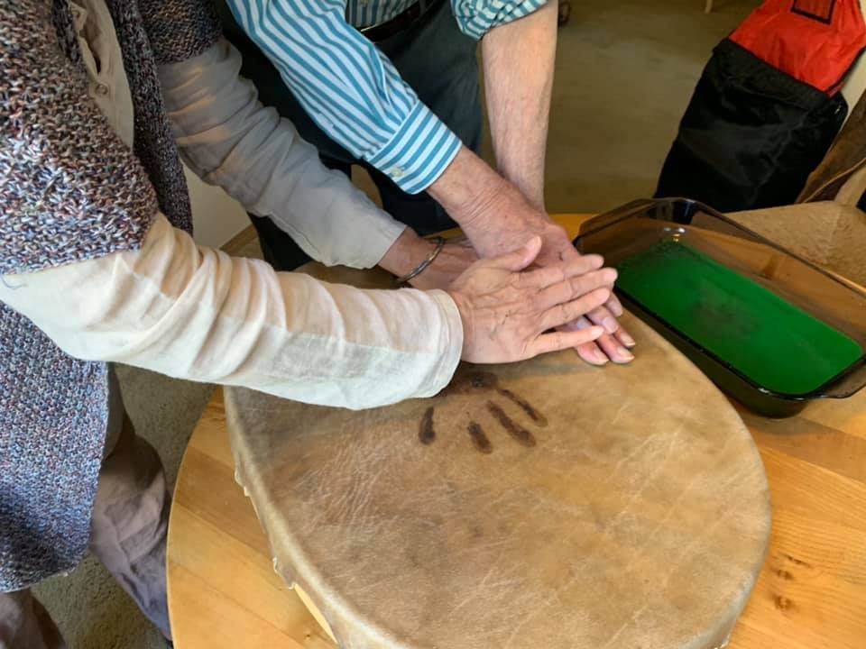 Our family Grancestor’s Drum: Helping Papa place his hand into the ink and then onto the Drum, right next to Mama’s handprint.
