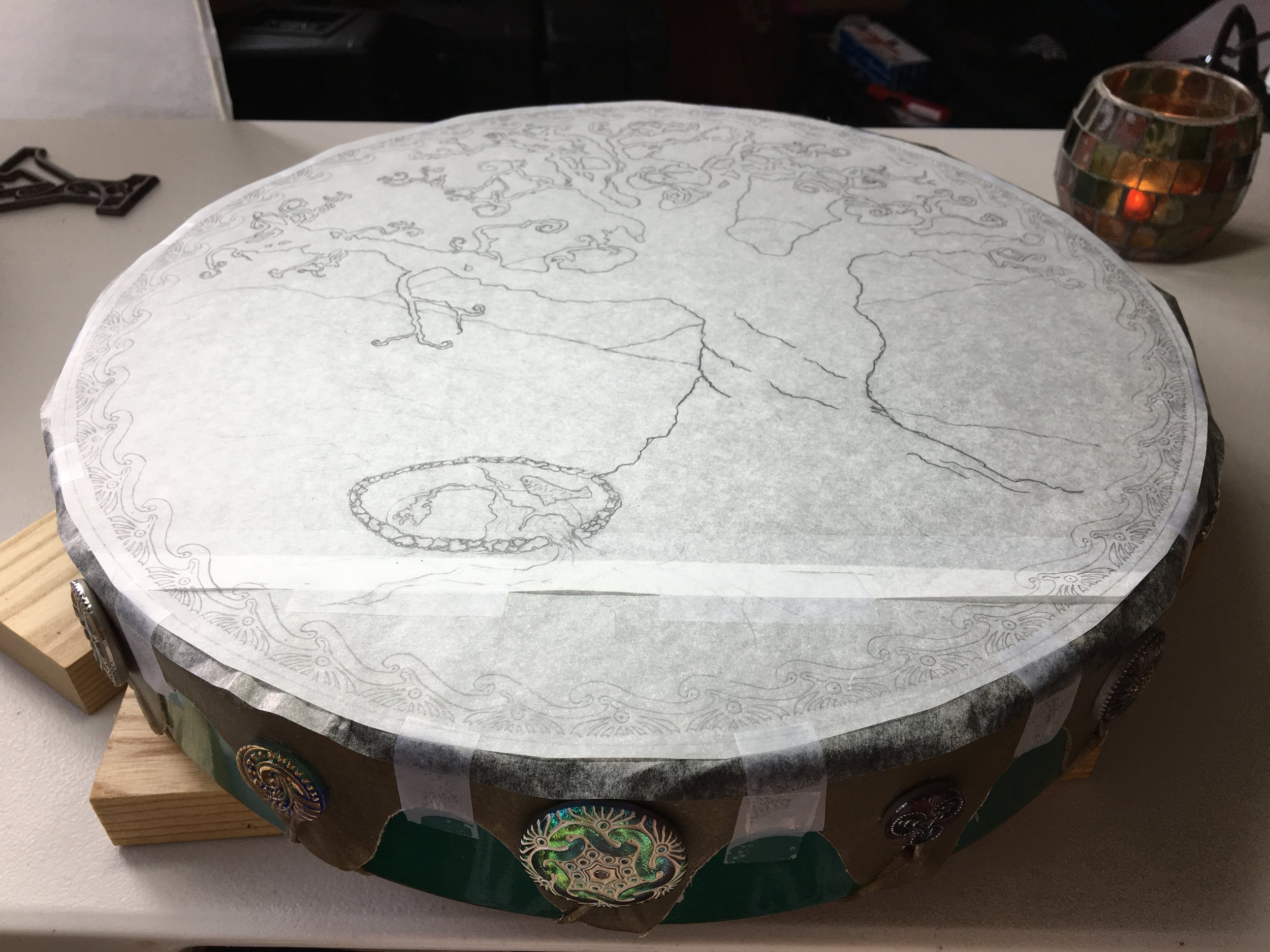 The drawing for Jeannie's "Blessings of Brighid" drum, laid atop the newly Birthed Drum, ready for transfer, and then inking.