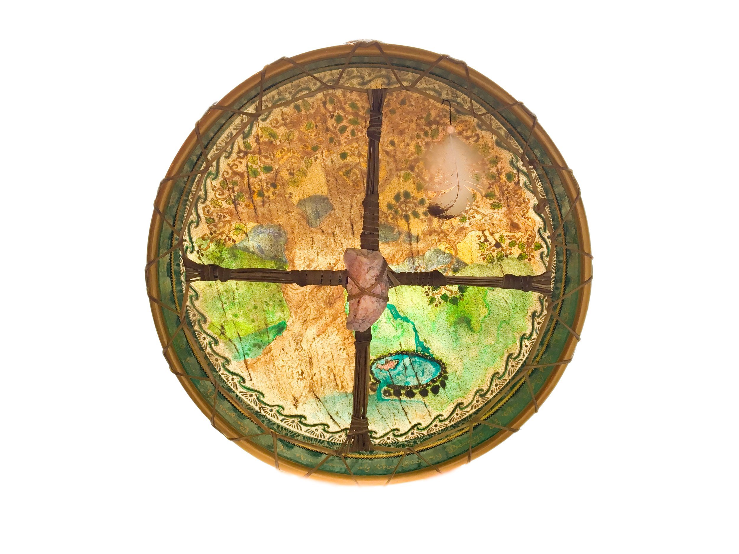 The back of Jeannie's "Blessings of Brighid" Drum, with her sacred Stone Person as hand-hold, and her Eagle feather attached.