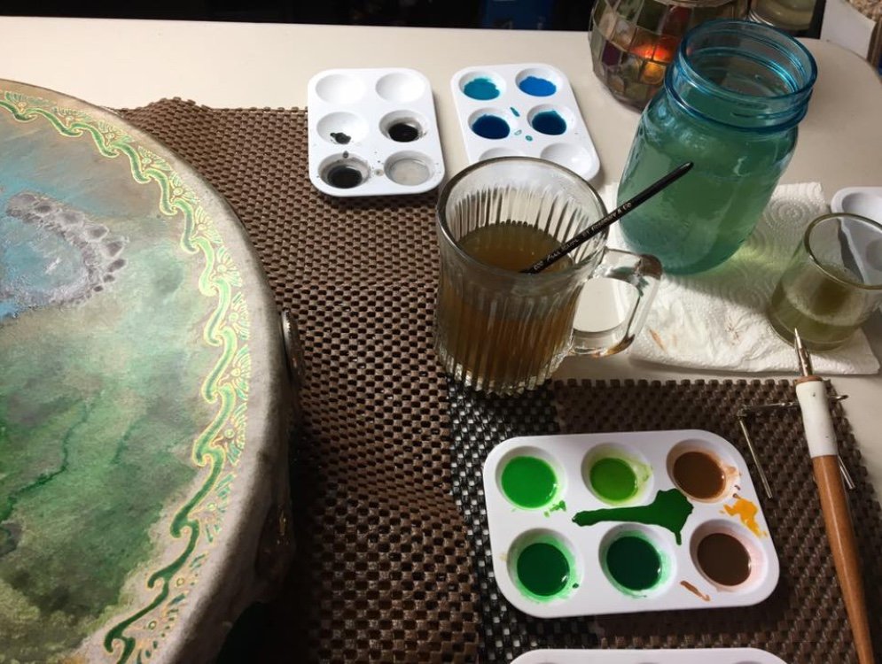 In the studio finalizing the inking of the "Blessings of Brighid" Drum - and a big oopsie as I rest my paintbrush in my tea mug, LOL.