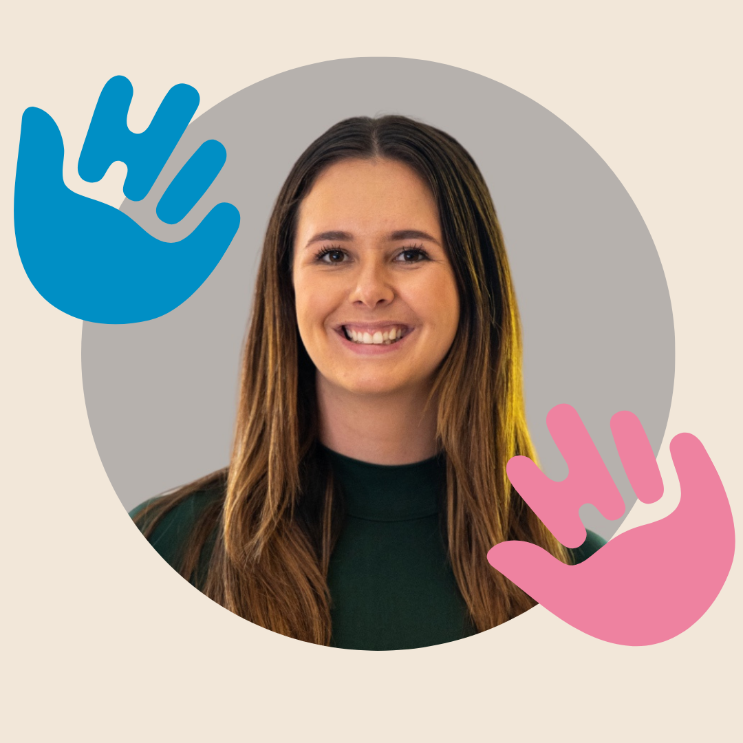 A woman with long brown hair smiles warmly at the camera. She is centred inside a circular frame on a beige background, with a blue hand graphic on the left and a pink hand graphic on the right.