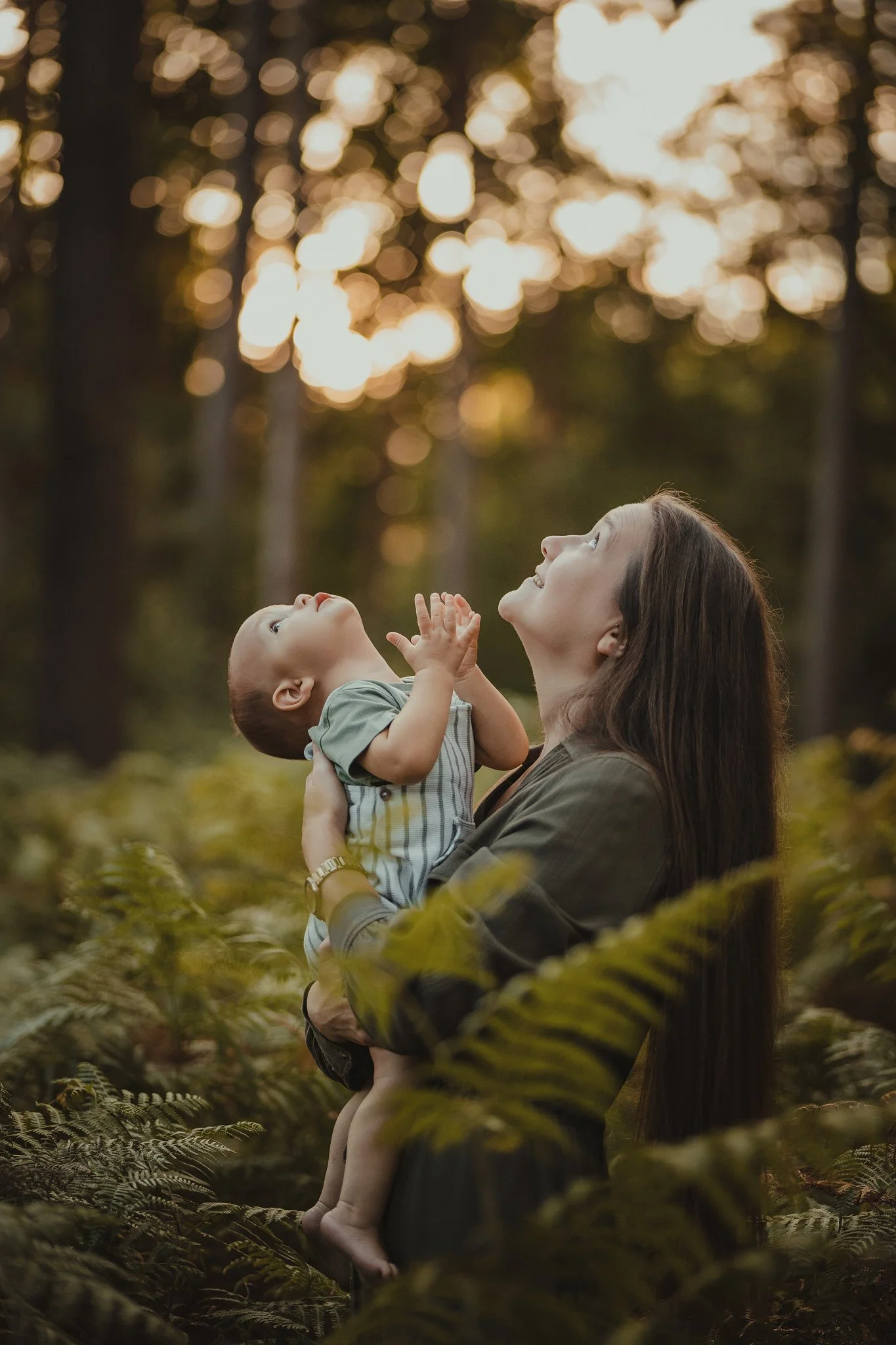 Mother and baby portrait in the woods enjoying sunset
