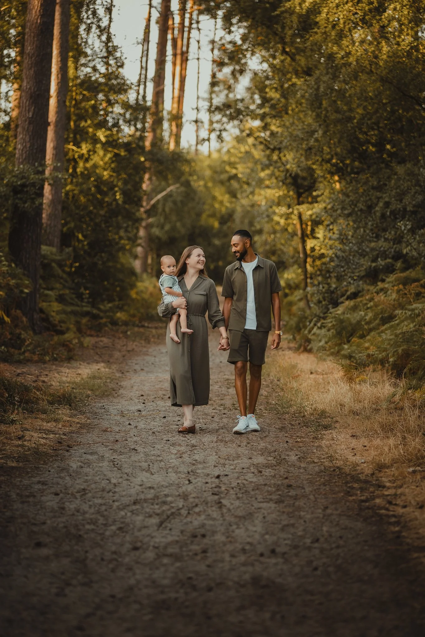 Family Portrait walking in the woods with baby enjoying the summer evening at golden hour