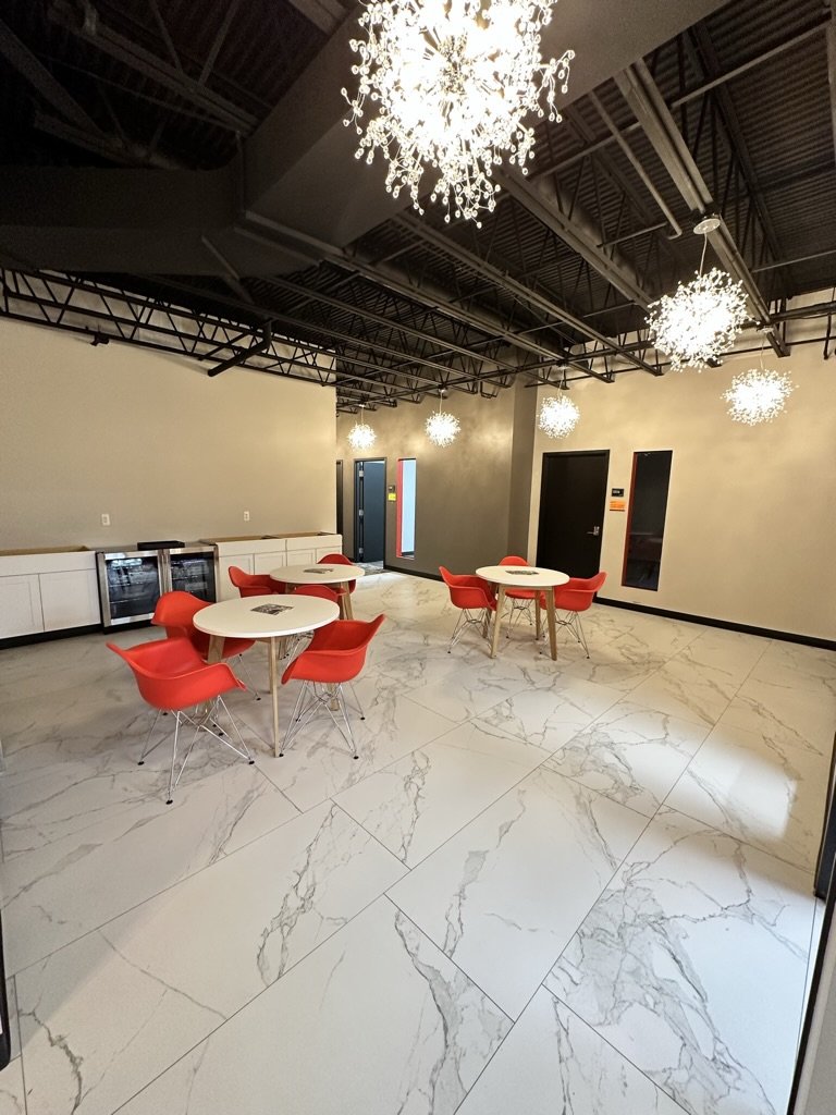 Open kitchen area. Includes sink, microwave, two refrigerators, (coffee coming soon) and seating for twelve.