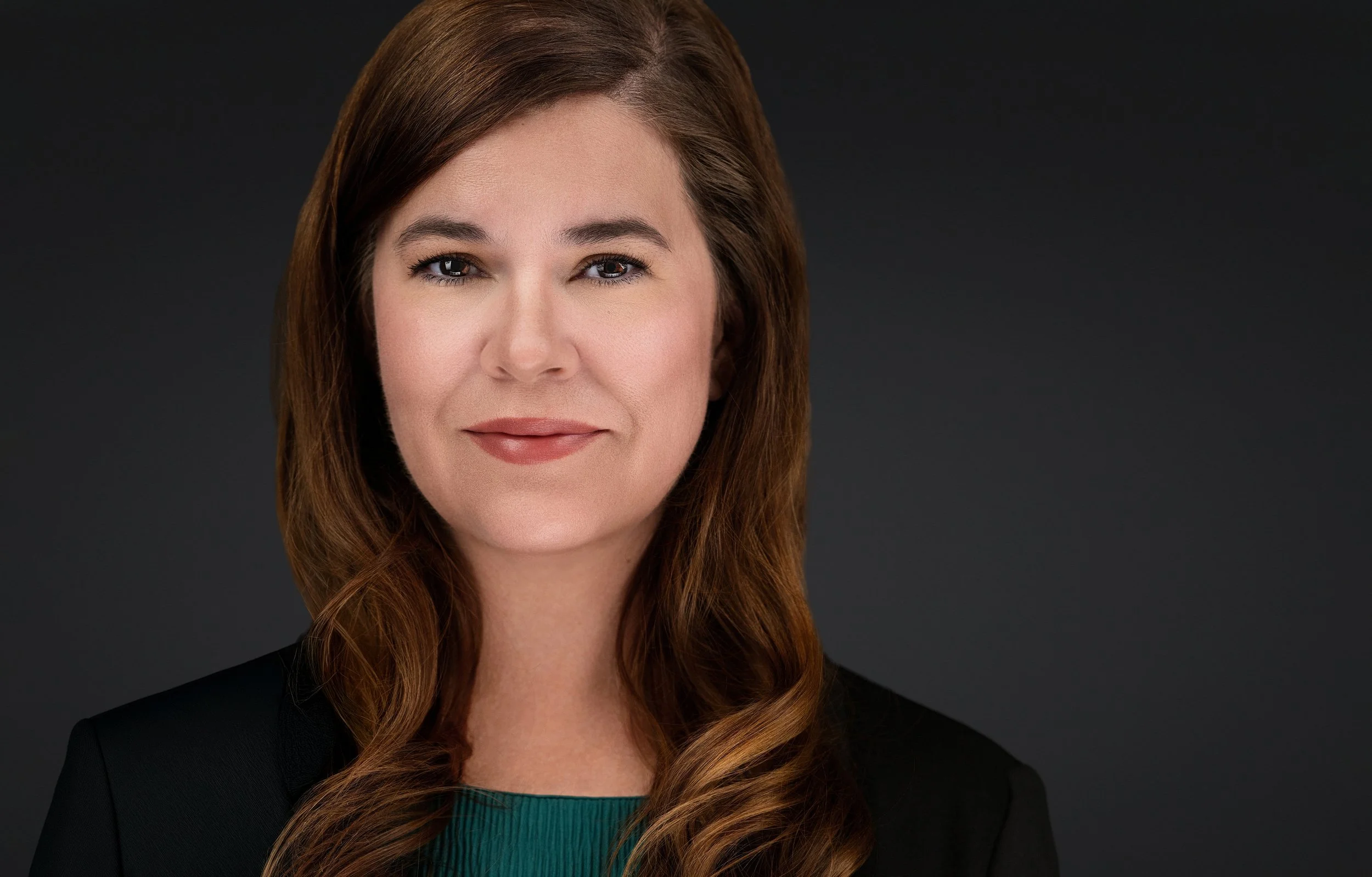 Yevette Lynn, professional photographer, captures a polished studio headshot portrait for personal branding with soft lighting and neutral background.