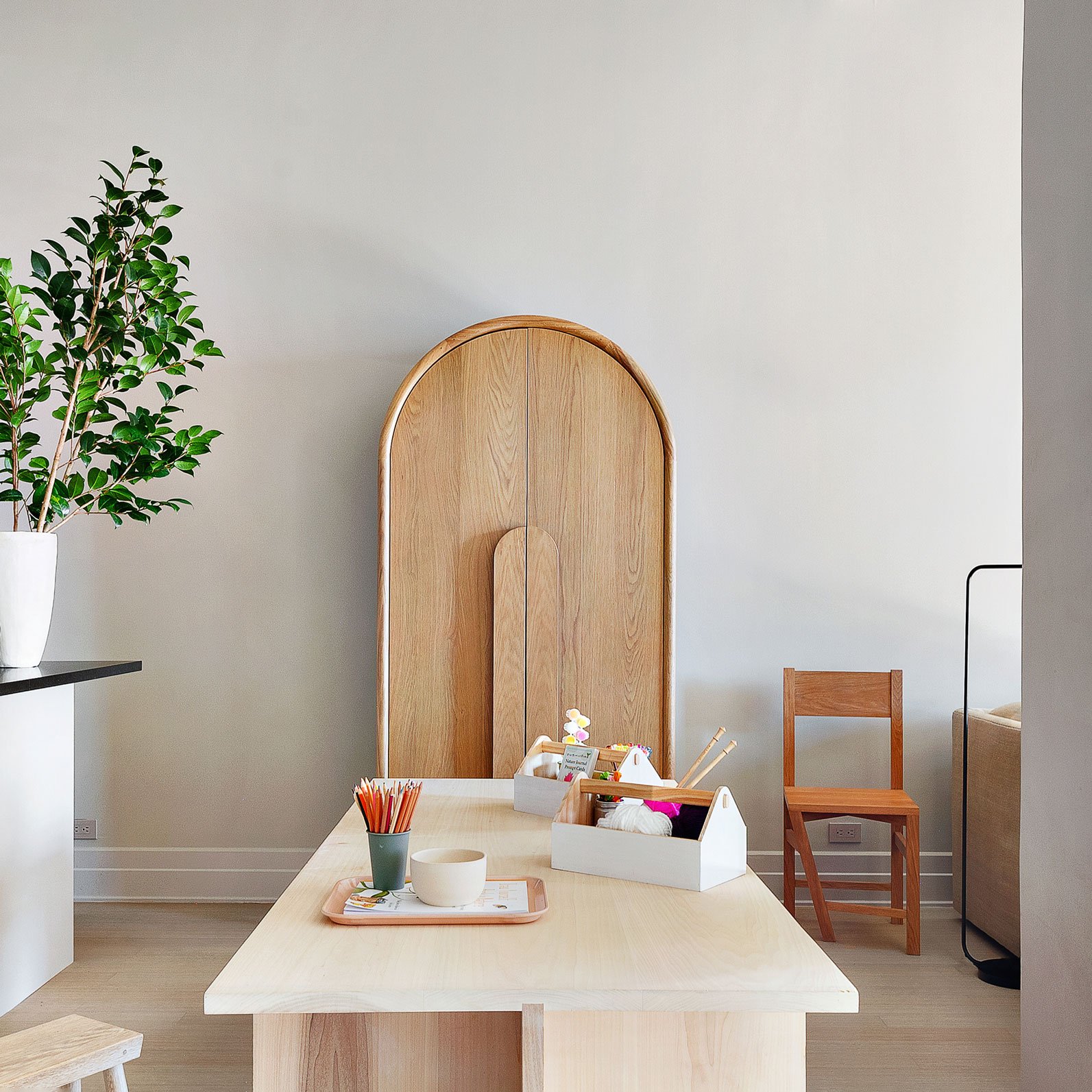 Apartment view: The 'Paradox of the Typical Atypical' chair's intriguing design, featuring a peculiarly angled leg, encourages a non-dualistic exploration of the ordinary and extraordinary.