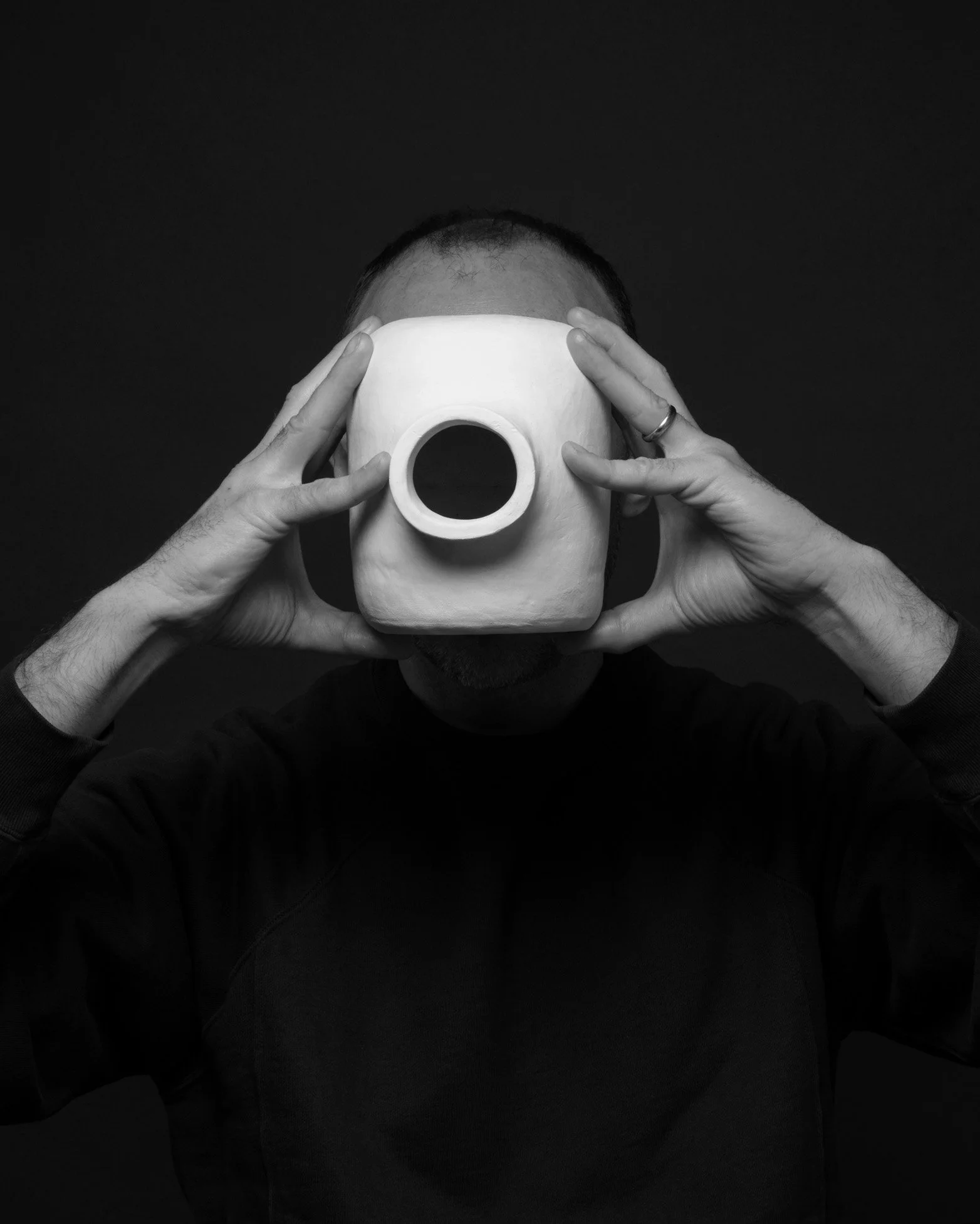 B&W photo of Martin Lenclos holding the vase