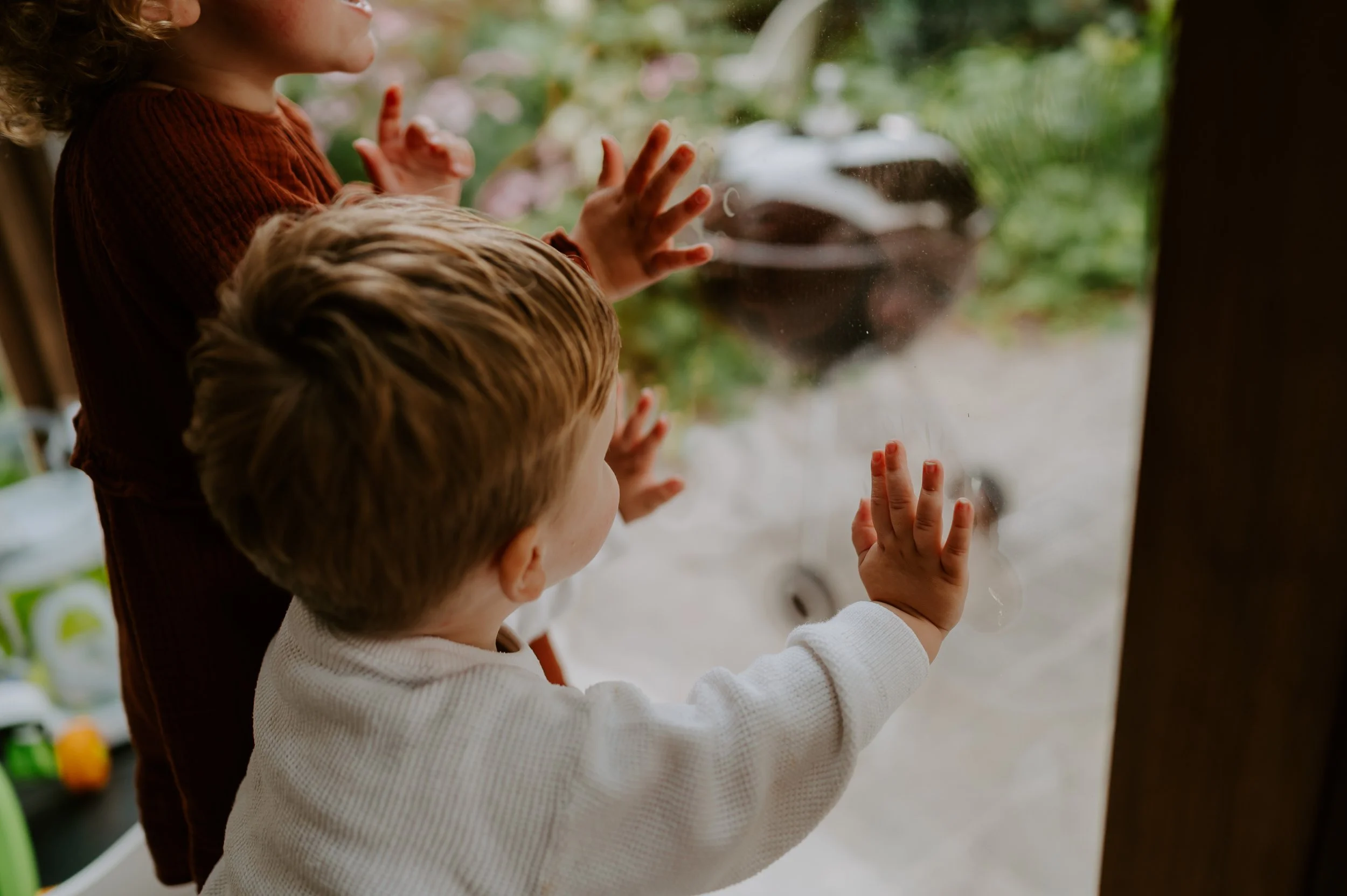 een momentje van de kinderen die hun handen op het venster zetten.