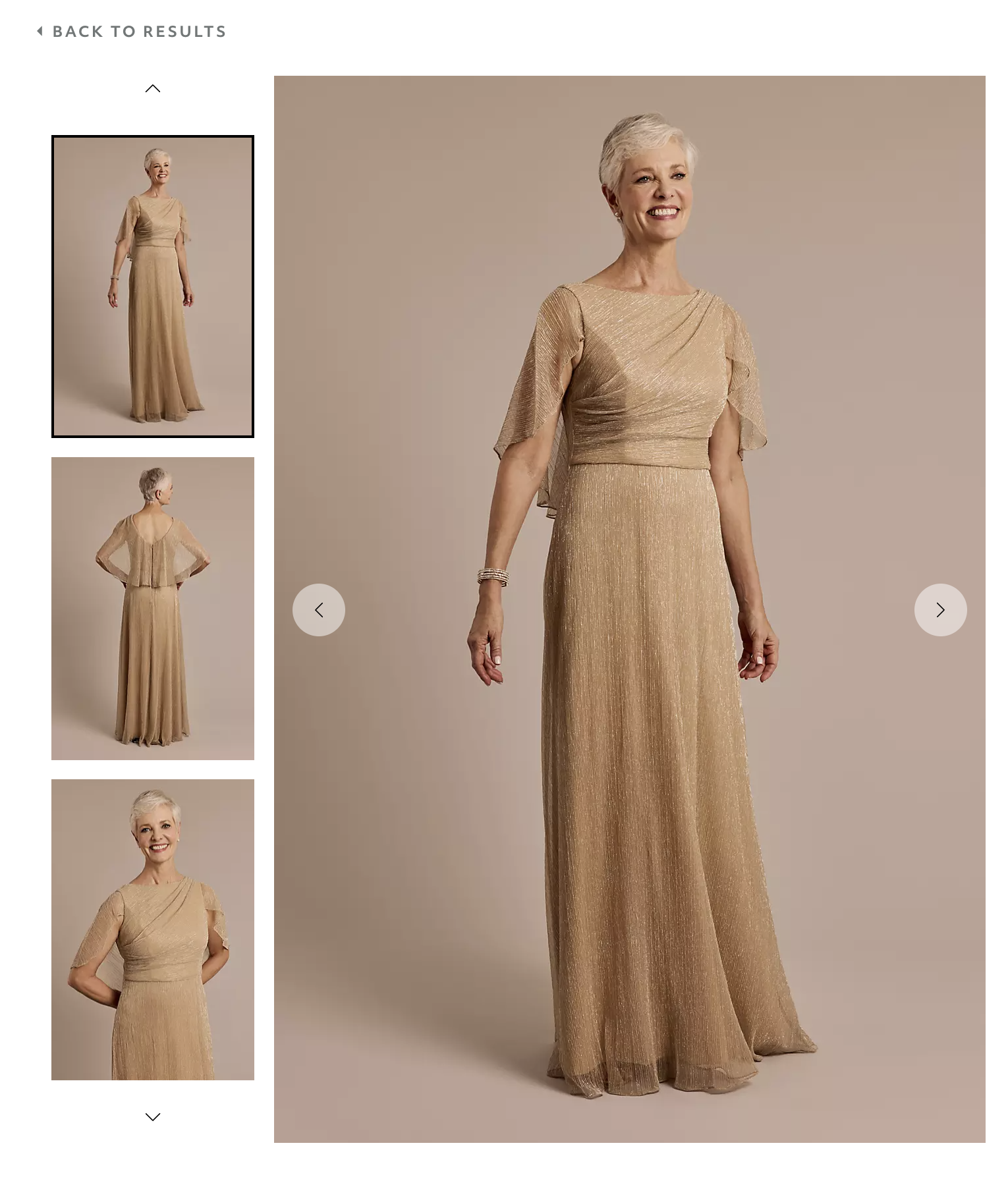 A mature woman with short gray hair wearing a gold, shimmery, floor-length gown with flutter sleeves, smiling and standing against a neutral background.