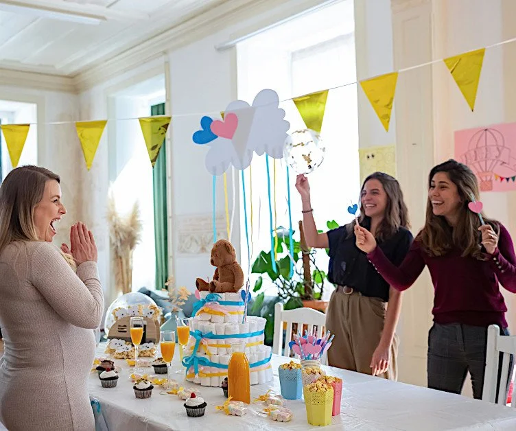 Pregnant mom celebrating a baby shower with guests.