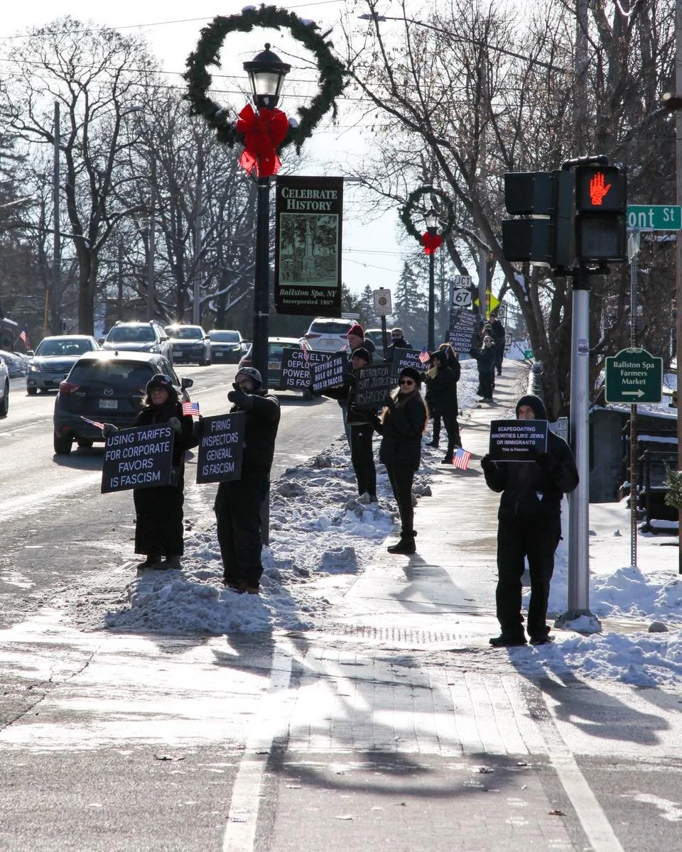 BALLSTON SPA &ndash; About two dozen neighbors braved the cold Saturday morning along Milton Avenue in Ballston Spa, standing in quiet solidarity for democracy and human dignity.

Dressed mostly in black and many positioned respectfully in snowbanks 