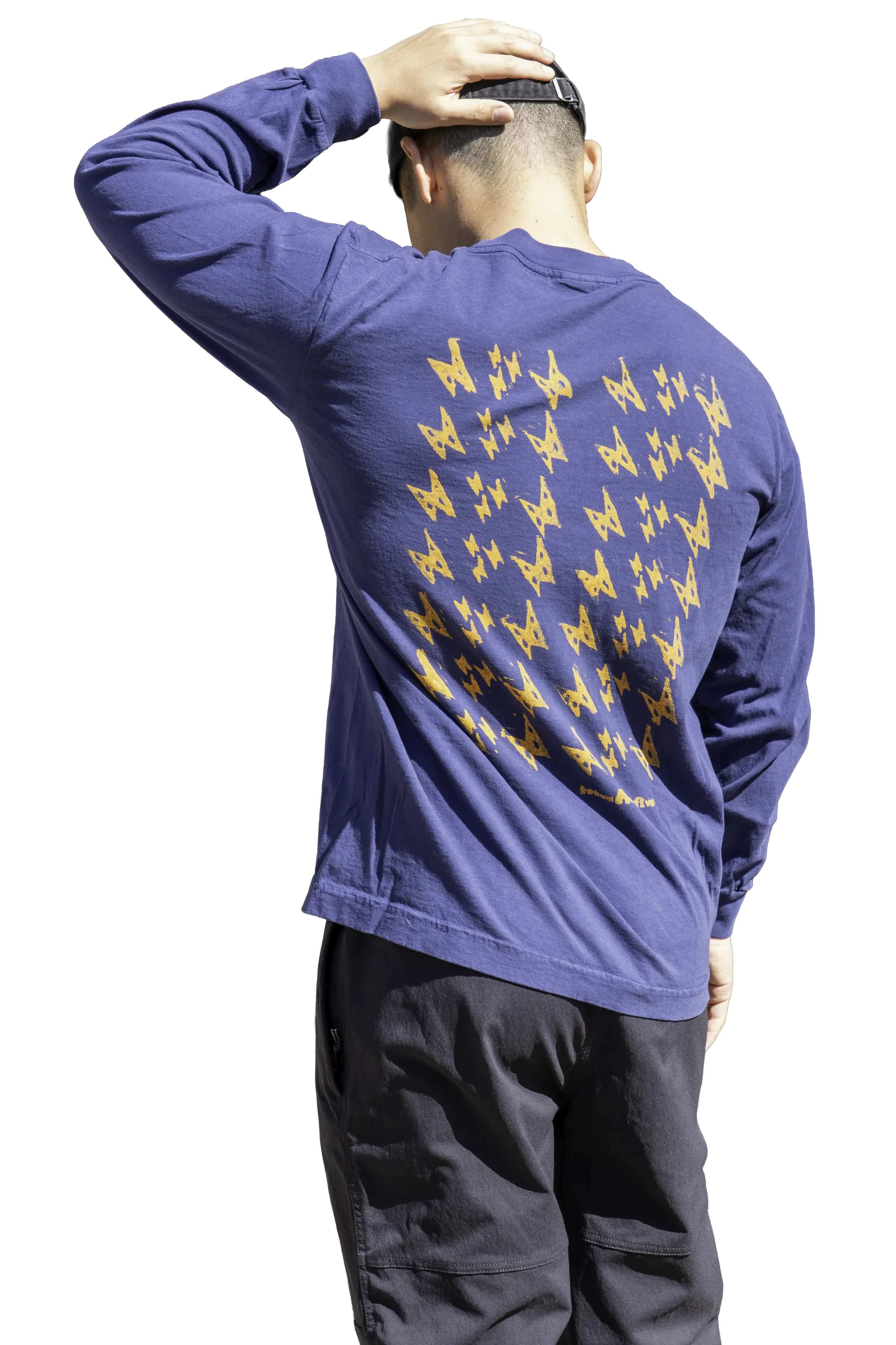 Back view of Kauila motif hand stamped in Lehua Mamo yellow Matsui Eco ink on dark navy long sleeve trash tee.